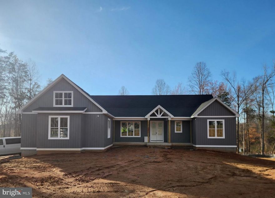 Professional photos and 3D tour coming soon! Experience elevated lake living in this brand new waterfront home on the private side of Lake Anna, Virginia, where luxury, comfort, and craftsmanship come together seamlessly. Built by award-winning Built Right Homes and nearing completion, this stunning Craftsman-style residence offers over 5,500 square feet across two beautifully designed levels. From the moment you arrive, the impressive 8-foot double front doors set the tone for what’s inside. Step into an open, light-filled floor plan featuring 9-foot ceilings, premium Mohawk LVP flooring, and a striking gas fireplace with custom built-ins. The gourmet kitchen is a true centerpiece, complete with a large island, quartz countertops, tile backsplash, stainless steel appliances, a 5-burner gas cooktop, double wall ovens, a farmhouse sink, and an oversized walk-in pantry designed for both function and style. With 6 bedrooms and 4.5 baths, there is space for everyone. The main level showcases two lakeside primary suites, each with its own private bath featuring beautifully tiled showers—one with a soaking tub—and both offering direct access to the deck overlooking the water. The main level also features two additional bedrooms that share a Jack-and-Jill bath, a convenient mudroom/laundry room and a half bath. The finished walkout basement expands your living space with a large family room, recreation area, two additional bedrooms, and a full bath. Plus, an extra 1,000 unfinished square feet offers endless possibilities—create a home theater, gym, or additional living space tailored to your needs. The exterior is just as impressive, featuring board and batten vinyl siding, 6-inch black gutters, and a partially covered back deck with a gas grill hookup—perfect for entertaining. Enjoy peaceful lake views from your level backyard, ideal for adding a pool, and take full advantage of your private dock with a sun deck already in place. Situated on a 1.5-acre lot in Compass Cove, Lake Anna’s newest subdivision, this home offers both privacy and convenience, just minutes from groceries, local dining, and Elk Creek Country Store. Whether you're cruising the lake, hosting unforgettable weekends, or maximizing income in this short-term rental friendly community, this is your chance to fully embrace the Lake Anna lifestyle—fun, relaxation, and memories all in one place.