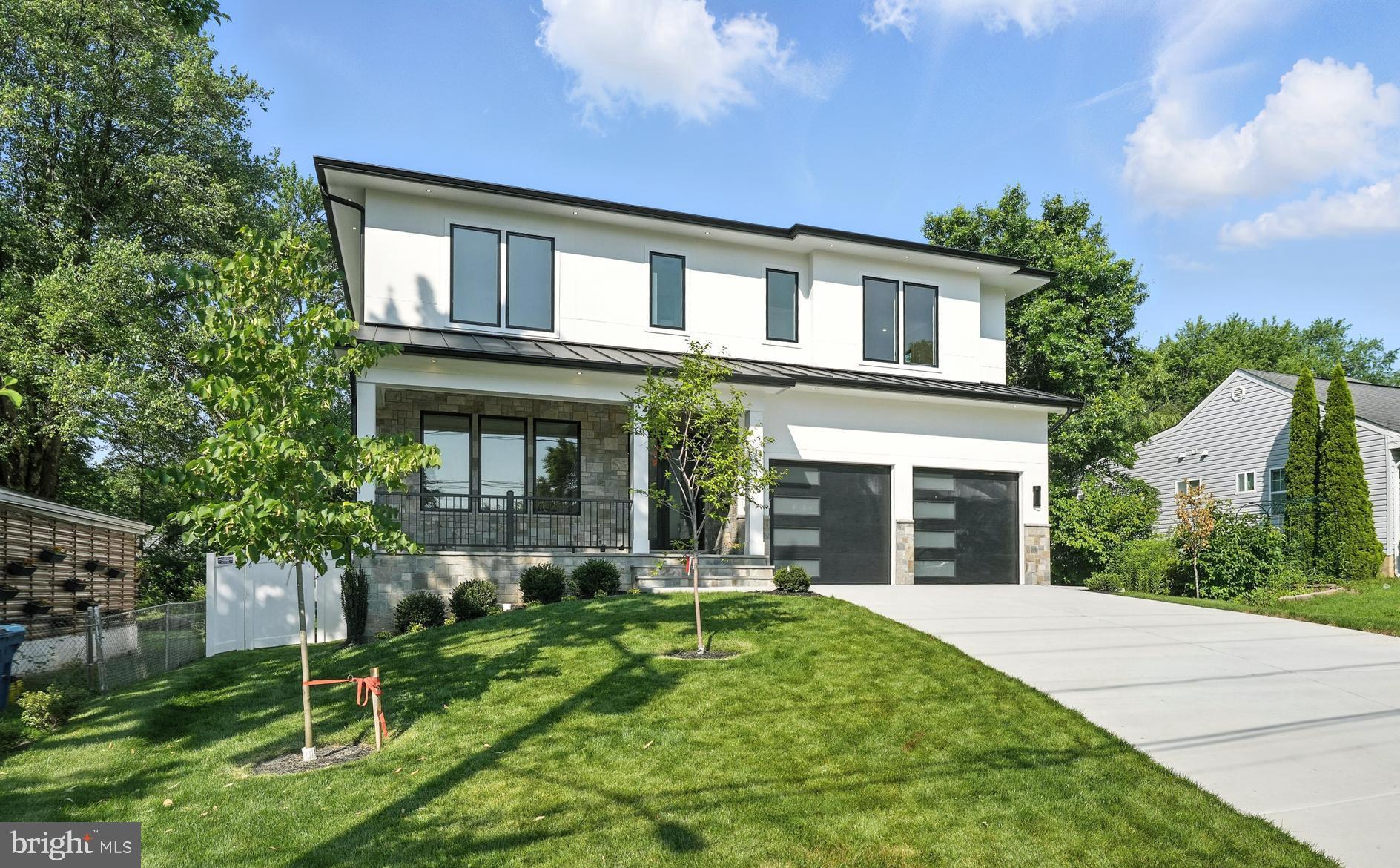 QUALITY CONSTRUCTION- GORGEOUS LOT - Located in a prime location between Tysons and McLean
This contemporary residence, encompassing around 6,638 square feet of open layout, offers an inviting atmosphere with its bold yet warm features. Constructed with premium materials and elegant modern finishes, the home is graced with large, beautiful windows that flood the space with natural light. It boasts suspended ceilings and hardwood floors on the upper levels, with luxury vinyl plank flooring on the lower level. The remarkable Chef’s Kitchen is equipped with 52-inch cabinets, Quartz countertops, a spacious center island featuring a waterfall edge, modern pendant lighting, state-of-the-art appliances, a generous walk-in pantry, and a dedicated dining area. The large family room includes an electric fireplace and suspended ceiling. On the main level, there is a versatile space that can serve as a bedroom or office,
complete with an ensuite bathroom. The Primary Bedroom Suite offers trey ceilings, an electric fireplace, a coffee wet bar with a beverage cooler, dual custom walk-in closets, and a luxurious primary bathroom with dual Quartz vanities, an expansive rain shower with body sprays, and a separate soaking tub. The upper level also features four private en suite bedrooms, each with a bath, along with a spacious laundry room with tiled floors, built-in cabinetry with a sink, and a sunlit window. The expansive walk-up lower-level entertainment area is bathed in natural light and includes a stunning Quartz wet bar with a beverage/wine cooler, dishwasher, and glass shelves, as well as a large rec room, a media room with wall sconces, a seventh bedroom with a walk-in closet, and a full bathroom. The exterior is beautifully landscaped with a stone front porch, a covered stone deck, and a 2-car garage featuring modern slit garage doors.