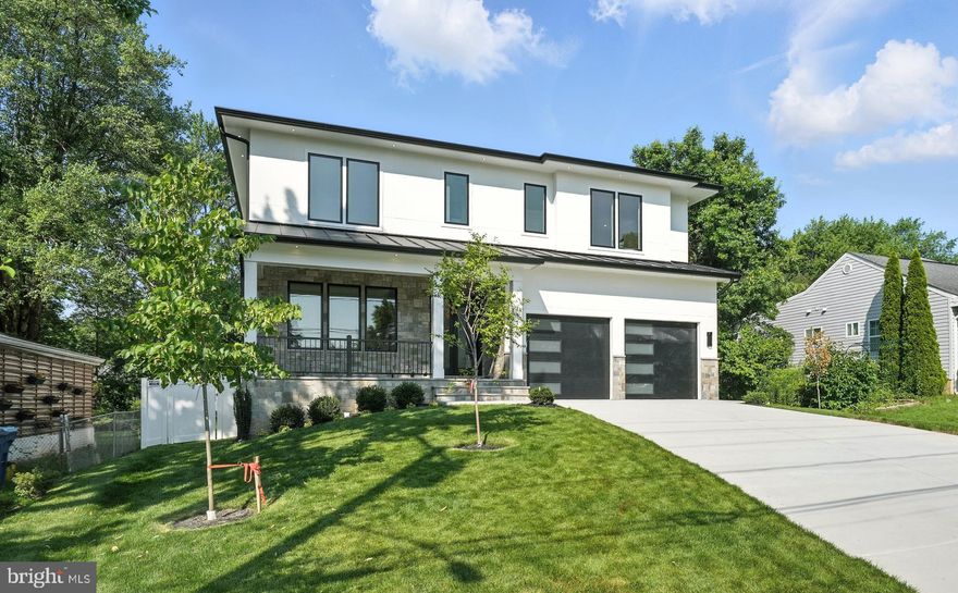 QUALITY CONSTRUCTION- GORGEOUS LOT - Located in a prime location between Tysons and McLean
This contemporary residence, encompassing around 6,638 square feet of open layout, offers an inviting atmosphere with its bold yet warm features. Constructed with premium materials and elegant modern finishes, the home is graced with large, beautiful windows that flood the space with natural light. It boasts suspended ceilings and hardwood floors on the upper levels, with luxury vinyl plank flooring on the lower level. The remarkable Chef’s Kitchen is equipped with 52-inch cabinets, Quartz countertops, a spacious center island featuring a waterfall edge, modern pendant lighting, state-of-the-art appliances, a generous walk-in pantry, and a dedicated dining area. The large family room includes an electric fireplace and suspended ceiling. On the main level, there is a versatile space that can serve as a bedroom or office, 
complete with an ensuite bathroom. The Primary Bedroom Suite offers trey ceilings, an electric fireplace, a coffee wet bar with a beverage cooler, dual custom walk-in closets, and a luxurious primary bathroom with dual Quartz vanities, an expansive rain shower with body sprays, and a separate soaking tub. The upper level also features four private en suite bedrooms, each with a bath, along with a spacious laundry room with tiled floors, built-in cabinetry with a sink, and a sunlit window. The expansive walk-up  lower-level entertainment area is bathed in natural light and includes a stunning Quartz wet bar with a beverage/wine cooler, dishwasher, and glass shelves, as well as a large rec room, a media room with wall sconces, a seventh bedroom with a walk-in closet, and a full bathroom. The exterior is beautifully landscaped with a stone front porch, a covered stone deck, and a 2-car garage featuring modern slit garage doors.