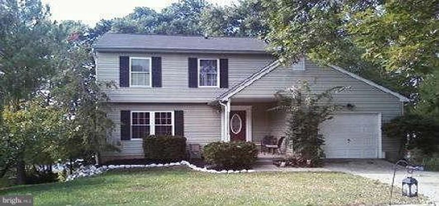 Hardwood Floors in Living & Dining Room - Family Room w/Wood Burning Fireplace & Sliders to 2-Tiered Deck - Pantry, Plenty of Cabinets & Family Sized Breakfast Bar in Kitchen - Spacious Fully Finished Basement w/Level Walkout to Lower Deck - Attached Garage & Covered Front Porch - Central Air & High Efficiency Gas Furnace - New Windows - Freshly Painted