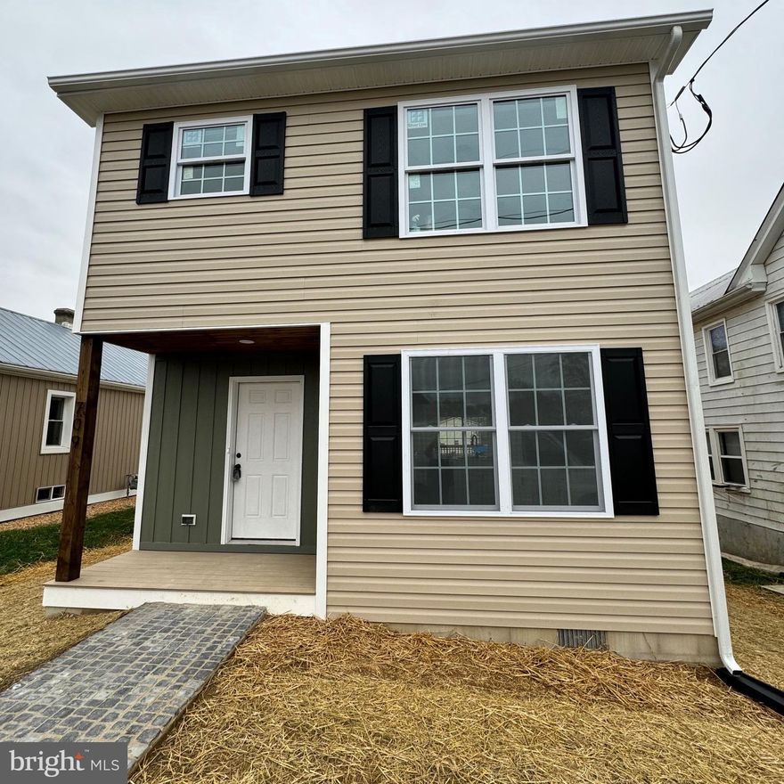 This newly-built home is located in an up and coming neighborhood in downtown Martinsburg.  This traditional two-story home has contemporary and semi-custom touches through-out such as an open-floor plan on the main floor and two large sliding glass doors that go out to a spacious wooden deck that overlooks a 0.2 ac lot. The entire first floor has been upgraded with 3-1/4” oak hardwood in a light stain.  The functional kitchen has a quaint nook area, granite counter tops, and a convenient pantry nearby.  Attached to the kitchen is a functional breakfast bar with a granite countertop  that can easily seat four that perfectly connects to the dining/living area. There is a conveniently placed powder room in the hallway near the kitchen.  The second floor has three carpeted bedrooms, two bathrooms with tubs and tiled walls, and a laundry area with hookups. The large master bedroom has a connecting bathroom with double sinks. Both bathrooms have vinyl LVP flooring. This beautiful home is conveniently situated near the historic Martinsburg downtown area and it is waiting for a new owner!