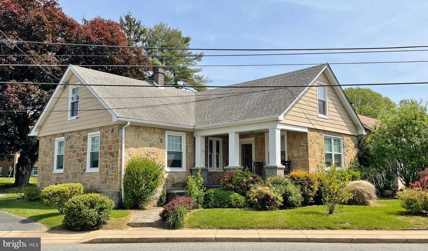 BEAUTIFUL STONE CRAFTSMAN CAPE COD HOME in town of Rising Sun.  Hardwood floors throughout.  Nice large living room, separate dining room, retro kitchen, 2 BRs, 1 bath on the main floor.  Second floor can be anything you want it to be:  1 BR, 1 bath, office, and upstairs tv room.  Stainless appliances in the kitchen, nice front porch, rear deck & ramp, stone patio, stone walkways, waterproofed basement, replacement windows, central air on first floor, baseboard hot water oil heat, detached garage.  Browse through the pictures and see how nicely kept this home is.  There even is a beautiful stained glass window in the front hallway. Easy walk to coffee shop, brewery, pharmacy, post office, library, banking.   Home is being sold to settle an estate, so is being sold "AS IS."  This is one of the nicer homes in Rising Sun.