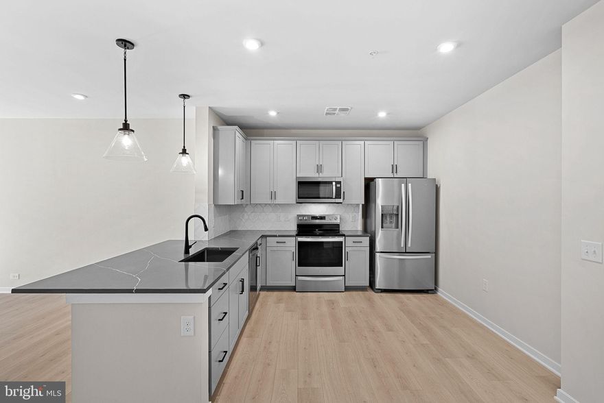 **FINAL HOMES** Special all-in price! Bradford home for immediate move-in. This 3rd- floor home has two bedrooms and two baths. Socializing is a breeze in your open-concept living & dining room. From the kitchen, find a flex space that you can transform into your own private retreat for work or your favorite hobbies. Relax and unwind in your spacious primary bathroom, equipped with an oversized shower & dual closets for your comfort. Bradford home offers flexible living space and generous closet space. The chef's kitchen opens to the living areas, providing the ideal space for entertainment. Blinds are included on all windows. Enjoy Oversized, frameless shower, dual closets, parking space and private storage unit, lighting and bath accessories in Matte Black, and kitchen cabinets in Painted Stone. Designer flooring: kitchen, living room , laundry. The balcony features a Revel in a resort-like getaway every day in Bradford. Dedicated covered parking space and storage unit included. **OPEN 10 AM – 5 PM, Thurs-Sun, By Appointment Only Tues-Wednesday** Receive 1 Year Paid of Condo Fees*, $12K* in Closing Costs Until 12/17!* See New Home Counselor for Details. Additional Restrictions may apply. Gatherings® at Potomac Station offers 55+ living near Leesburg’s vibrant dining, live music, and art scene. Enjoy green spaces like Ida Lee Park, top healthcare at Inova Loudoun, and easy access to shops, trails, and cultural events. This vibrant community includes a private fitness center & yoga studio and a center courtyard with walking path. Perfect for an active lifestyle! With low-maintenance design and fewer common repairs, you’ll spend less time on upkeep and more time enjoying the comfort of home. Enjoy a life free of yardwork or shoveling. Landscaping and upkeep are handled for you, so you can spend your time how you want to. Look for parking along California Avenue near the paved steps/ramp between the main buildings. Follow the signs and take the steps or ramp to our building entrance. Please use keypad to call our 2nd-floor SALES OFFICE.