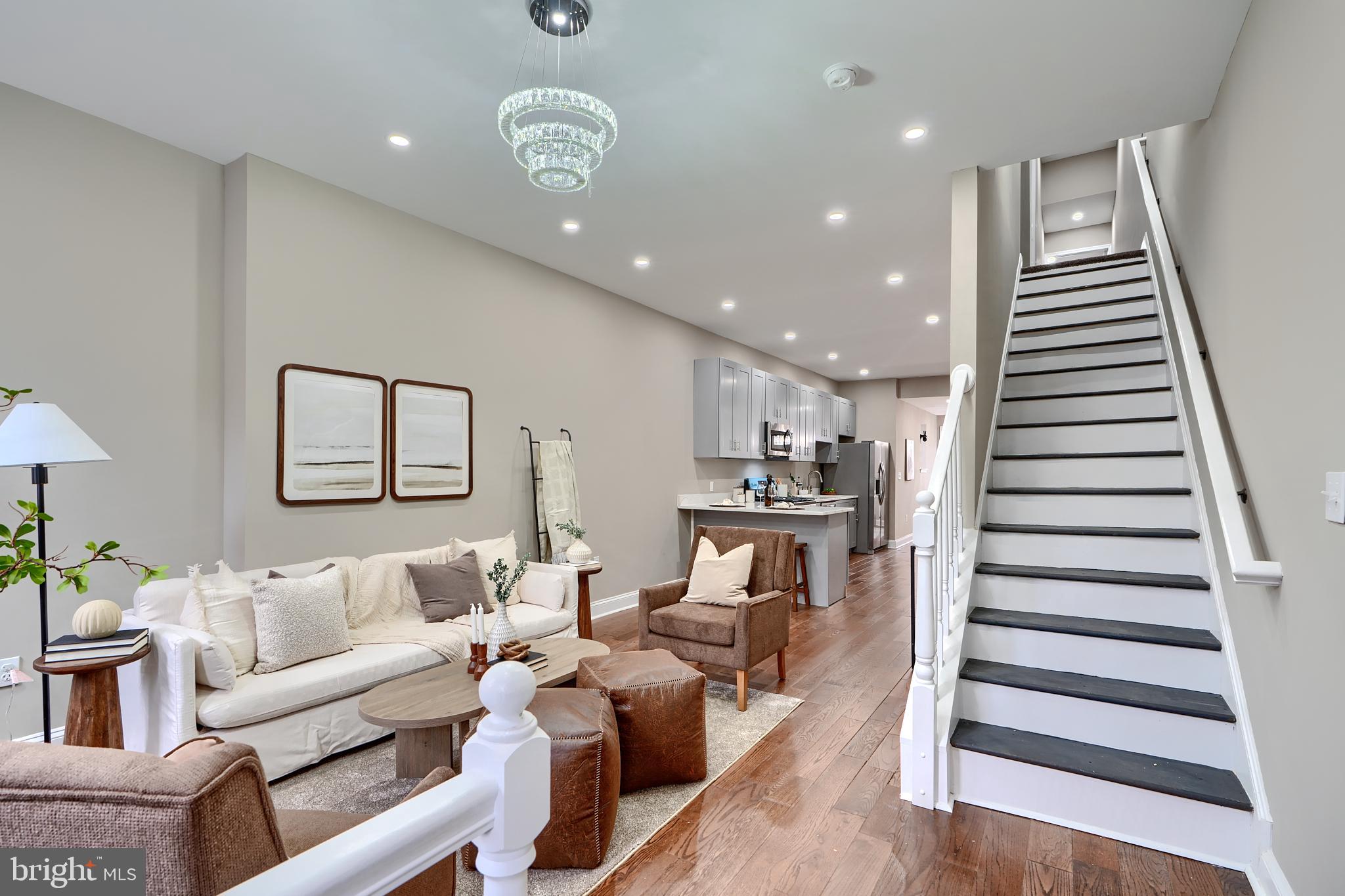 **Please note there are a bunch of properties on the block currently being renovated and some are about to begin renovation and are just waiting for drawings to be approved! **
Welcome to 1818 Druid Hill Ave – A Beautifully Updated Home with 5 Bedrooms and 3.5 Bathrooms!
Step into a meticulously designed home that seamlessly blends modern comforts with elegant style. As you enter, you are immediately greeted by a spacious and inviting living room, featuring custom lighting and stunning flooring that runs throughout the main level. This home is truly designed for both relaxation and entertaining. The gourmet kitchen is a chef’s dream, equipped with stainless steel appliances, sleek quartz countertops, and extra-tall cabinetry offering ample storage space. The kitchen also features a bar area with seating, making it the perfect spot to enjoy a quick meal or entertain guests. Adjacent to the kitchen is the bright and airy dining room, with large windows that flood the space with natural light. A stylish chandelier adds a touch of sophistication, and the back door opens up to a fully fenced yard and a charming patio, ideal for outdoor gatherings and relaxation. Upstairs, you'll find 3 spacious bedrooms, a laundry room and a luxurious full bathroom. But the real gem of this home is the upper floor – an expansive primary suite that spans an entire level. The suite is a true retreat, complete with a magnificent spa-inspired bathroom featuring a soaking tub, dual vanities, and a walk-in shower with two elegant wall mounted shower fixtures. The gorgeous tile work throughout the bathroom adds an extra touch of elegance. The fully finished basement offers additional living space with the large rec room and it also includes a bedroom and a full bathroom, making it an ideal space for guests or multi-generational living. This home is eligible for various grants, making homeownership more accessible than ever. Don’t miss out on the opportunity to own this exceptional property – come see it today and make your dream of homeownership a reality!