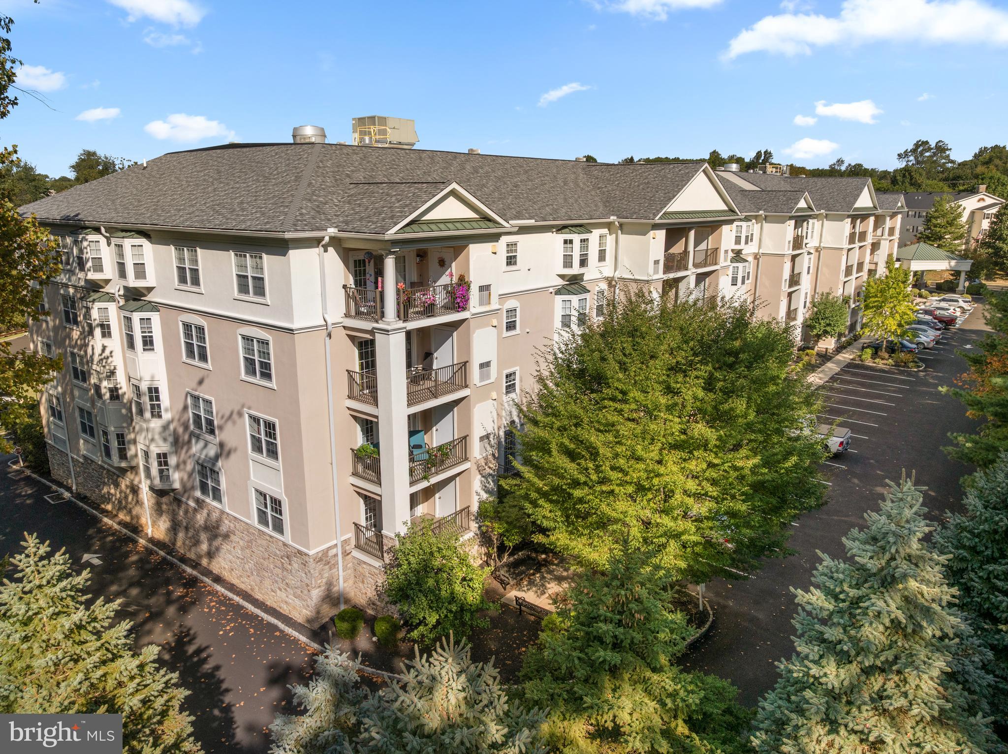 OPEN HOUSE SATURDAY 1-3PM. Welcome to this sun-lit, 2-bedroom, 2-bathroom condo located in the pet-friendly Windsor at Glen Mills, a vibrant 55+ community. This beautiful home is strategically positioned as a back corner unit, offering unparalleled privacy and an abundance of natural light through its additional windows. Step inside to discover a spacious 1,394 square feet layout with modern amenities tailored for comfortable living. The open-concept kitchen is open to the dining area, perfect for casual dining. Adjacent to this is a generous living room, featuring a slider that opens to a charming side porch—ideal for relaxing and enjoying the serene surroundings. The primary suite is a retreat, boasting a bay window and a walk-in closet. Its ensuite bathroom is equipped with a convenient stall shower. A second bedroom provides ample space for guests or home office needs, while the hall bathroom features a versatile tub/shower combination. Additional highlights include ample closet space, a separate laundry room with included washer and dryer. This unit includes a parking spot (#1) and additional storage space on the garage level. (#1) Windsor at Glen Mills offers community amenities, including an outdoor pool, a well-equipped exercise room, and inviting common areas such as a billiard room and library, meeting and party rooms. The association fee covers essential services like lawn maintenance, trash removal, and water, allowing you to enjoy a low-maintenance lifestyle.