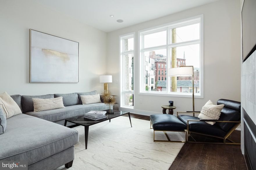 Amazing unit at Liberty Square. This stunning 4 bedroom home is a true stunner. The home features a massive open floor plan with huge custom Porcelanosa kitchen, hardwood throughout and fully tiled bathrooms with floating vanities. The first floor features a great size office and a huge 2 car garage. Head downstairs and you will find a massive finished basement with endless possibilities. The main living area features a designer kitchen with Bosch appliances, quartz countertops and high end appliances. There is also a deck off the kitchen which is perfect for grilling. The third floor features to en-suites, laundry room and a large deck! The HUGE owner suite takes the entire 4th floor. There is so much closet space in this home. The gorgeous owner suite bathroom features double shower heads, free standing tub and two separate vanities. The roof deck is not your average deck. It is leveled with Porcelanosa tiles to make is a durable yet attractive outdoor space. Don't miss your chance on the last corner home left in Liberty Square with 2 car garage. Photos are of home with same floor plan. Check OPA for 2019 taxes due to possible citywide reassessment. square feet is approximate and includes both below grade space and above grade. The source is from the builder and public records.