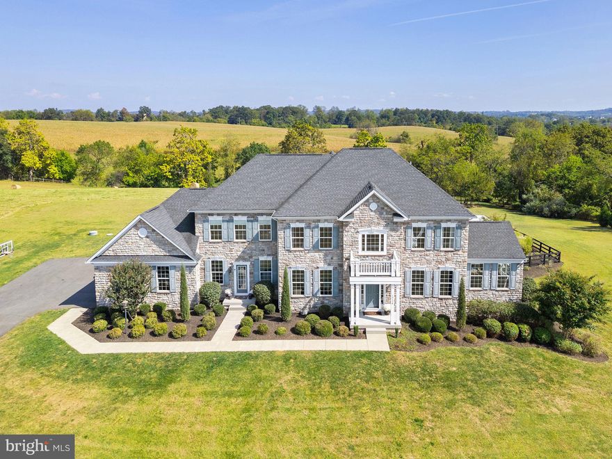 VIEWS VIEWS VIEWS! Exquisite 15-Acre country estate with pool, breathtaking  sunrise AND sunset mountain views and resort-style living. Perched on a scenic hilltop that backs to 155-acres of conservation land, this gorgeous property offers panoramic mountain vistas, breathtaking sunrises and sunsets, and rolling pastures-- perfect for fall hikes, campfire nights and outdoor gatherings. 

Here you’ll find an elegant stone-front estate complemented by a stunning resort-style saltwater pool w/ hot tub and outdoor entertaining spaces, all within a neighborhood of other large-acreage homes. Located on a quiet cul-de-sac, this property provides privacy and the perfect setting to embrace the surrounding beauty of nature.

The outdoor living is truly unmatched—relax by the sparkling saltwater pool with adjoining hot tub, gather around the gas fire pit on cool evenings, or enjoy the dramatic waterfalls and unique jumping boulder that make every day feel like a getaway.  Soak up the sun on the large tanning ledge, complete with the option for a built-in umbrella. Backyard oasis would cost $500k to replicate today.  A second wood-burning fire pit area located in a wooded enclave offers a cozy camping atmosphere -- great for family adventures!

Inside, the warm and inviting interior welcomes you with soaring ceilings, breathtaking views from every window, and exquisite custom details throughout. Offering five spacious bedrooms and four and a half baths, this residence was thoughtfully designed with impeccable attention to detail.  Ideal for both everyday living and grand entertaining, the open-concept gourmet kitchen features custom cabinetry, stainless steel appliances, and an expansive island with seating for four.  In the family room, elegant trim work and a coffered ceiling with wood plank accents add warmth and character, creating a space that feels both refined and inviting. A main-level office provides the perfect setting for working from home or managing household affairs with ease. Upstairs, the spacious primary bedroom boasts gorgeous sunrise views, a large sitting area, and two MASSIVE walk-in closets. The walk-out lower level opens to the pool deck and is made for family entertainment with a fabulous theater room, game room and guest bedroom and full bath. 

Conveniently located, the property is 6 miles to Purcellville, 11 miles to Downtown Leesburg and 35 minutes to Dulles International Airport. This stately residence offers stunning views, extraordinary outdoor living and timeless architecture, all in a serene horse-friendly, country setting. Don't miss this incredible  opportunity!