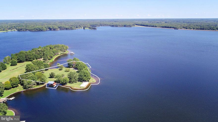 RARE OFFERING of one of the last remaining premium waterfront parcels on Lake Anna's Public side!!  Enjoy the exclusive use of this panoramic peninsula - approximately 3 WATERFRONT ACRES (deeded acreage + Dominion easement).  Many EXISITING IMPROVEMENTS CONVEY, including: detached 2+ car garage with full bathroom, boathouse with electric lift and storage plus an additional floating dock, a huge sandy beach, private boat ramp and 1,000 feet of rip-rap shoreline!  Build the house of your dreams and an additional boathouse... plans already approved for a main residence up to a 3,000 sq.-ft. footprint with new garage, plus an additional boathouse!  Existing log style detached garage could be easily converted to guest space or separate rec. room - bring your imagination!  Additional usage possibilities include: WEDDING VENUE and/or 2 RV sites.  Level parking available for 2 RVs, with 50-amp electric hook-up and sewage disposal connected to existing septic!  Don't miss this extremely rare NON-HOA waterfront compound! Professional aerial drone footage and video coming soon!