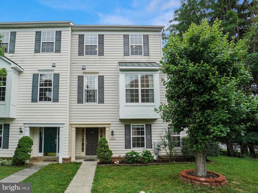 NEW ROOF AND NEW CARPET THROUGHOUT!! This light-filled end unit townhome is ready for you to move in! The spacious foyer leads to a massive first level bedroom with a sitting area and a full bathroom. The lower walk-in level also features a  kitchen with granite countertops and a walk-out to the fenced backyard with a patio--great for entertaining.  This area is perfect for an in-law suite! On the main level, you will  find beautiful gleaming hardwoods to greet you. Enjoy your morning coffee on the freshly stained deck and enjoy the privacy backing up to woods! The massive living room flows into the kitchen with stainless appliances.The upper level Owner s Suite features a large walk-in closet and spa bath with separate shower and tub. Plus two large bedrooms and a hall bath. This massive townhome is over 2,500 sqft! It won't last long!