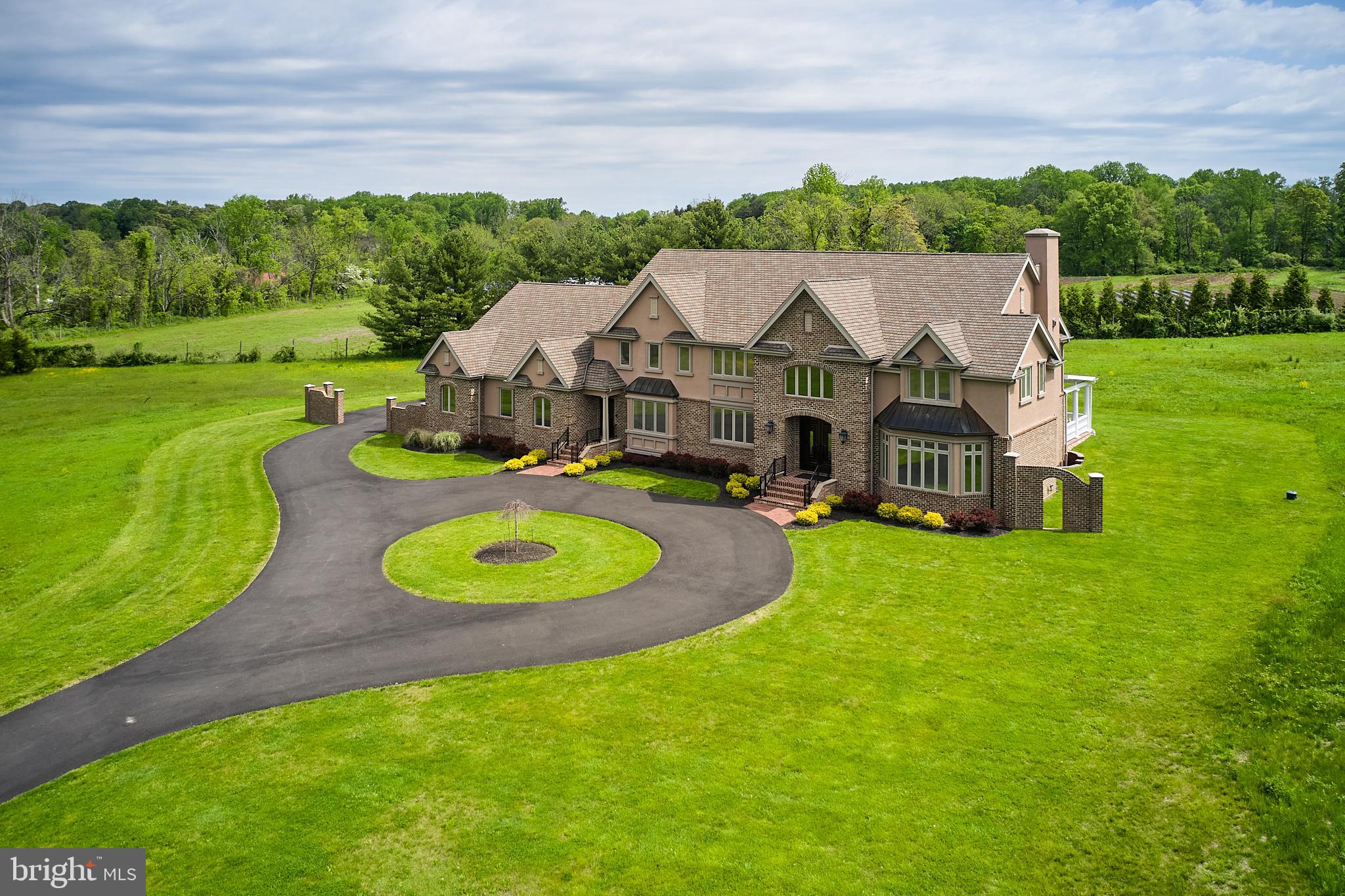 The Private Estate! The Convenient Location! The Ultimate Lifestyle! You Got It All Right Here! Only minutes from the bustling River Towns of New Hope & Lambertville, fabulous restaurants, coffee shops, boutiques, art galleries, golf, Delaware Canal Towpath, so much more! Quality upscale amenities abound in this one-of-a-kind, impeccably crafted Manor Estate graced by a sweeping, circular driveway. State-of-the-art Geothermal heating & cooling systems provide 8-zone money-saving energy efficiency. Smartly-situated Elevator offers added access to all 4 levels. Ideal for Multi-Generational Living! Large Private Office features direct access to the Secondary Front Entrance, double doors, window seat & scenic views. This lavish Estate boasts 2 Primary Bedroom Suites! Suite One has a dramatic double-door entrance, a romantic double-sided fireplace with onyx hearth, tray ceilings, 2 spacious walk-in closets, designer glass doors & a separate Sitting area. Suite Two showcases gorgeous columns, elegant double doors to a spacious walk-in closet & elegant double doors to the Bath, plus a separate Sitting area. Both Suites have sumptuous, spa-like Baths with tray ceilings, double vanities, showers, soaking tubs, radiant heat. Two additional deluxe-sized Bedrooms each have a walk-in closet & share a deluxe bath with double vanities, shower, window seat and radiant heat. Perfect for the In-Law Suite or other desires is the expansive unfinished space conveniently located near the Elevator & secondary staircase. On the 1st Floor, stately Front Entrance double doors welcome guests into a stunning Grand Foyer with a spectacular floating staircase, magnificent arches, captivating balconies & opulent chandelier. Sophisticated sunken Living Room dazzles with impressive walls of windows bestowing panoramic views of nature. Cook, dine & entertain in the expansive Gourmet Kitchen fully equipped with 2 ranges, an oversized island with additional prep sink & seating, abundant cabinetry, walk-in pantry, a designer desk, more. Exquisite polished pebblestone-filled Planter, with columns & fine millwork, creates a warm harmonious balance in the heart of the home. The inviting Breakfast Room with glorious rounded windows reveals picturesque panoramic views & at night, the star-filled sky & moon. For formal entertaining, there's a well-appointed Butler's Pantry plus elegant Dining Room accented by 3 majestic columns, a tray ceiling, graceful chandelier & ceiling medallion. Enter the Great Room through tall French doors & discover a floor-to-ceiling ledge-cut stone fireplace. Oversized hearth, perfect for cozy comfort or party seating, is flanked by grand built-in bookcases. Move the fun outside through glass sliding doors onto the expansive covered Terrace. Massive Roman columns with custom balusters overlook the private backyard oasis. This Estate has 2 classy 1st Floor Powder Rooms, oversized Laundry Room and plenty of closets. Luxuries throughout include exceptional lighting, convenient chandelier lift, all-wood cabinetry with soft-close doors & roll-out drawers, distinctive millwork, quartz countertops & high-end casement windows. Enormous Garage has room for 3 cars plus room for more, high ceilings, natural light, a separate entrance, double sink and closet. Enormous dry Basement with 9-ft ceilings is a premium space for Multi-Generational Living, entertainment, recreation & more! ! In the Award-Winning New Hope-Solebury School District, this sprawling property has over 6 acres of desirable level land with tree-lined borders. Ideal for any outdoor activities! This modernly luxe Estate is practically Brand New & Move-In-Ready! Easy access to Philadelphia, New York, Princeton, Poconos, Jersey Shore. It's All Right Here! Luxury, Privacy, Convenience in Desirable Bucks County!