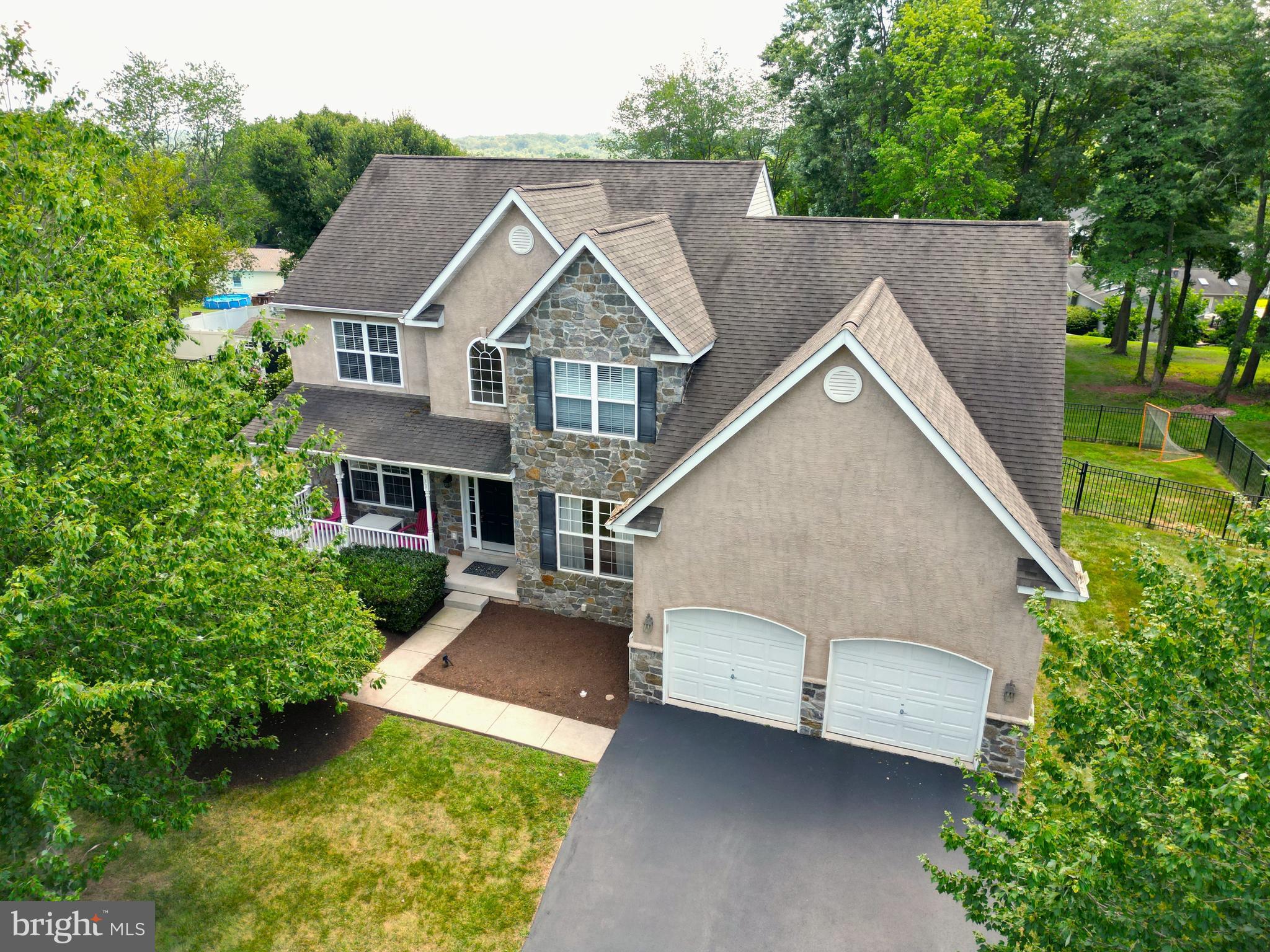 Nestled in the prestigious Church Hill Estates, this exquisite Colonial home, built in 2006, offers a harmonious blend of elegance and comfort. Offering 4 bedrooms and 2.5 baths with 2,932 square feet of meticulously designed living space, this residence is a true sanctuary for those who appreciate high-end features and an exclusive lifestyle. Step inside to discover a warm and inviting interior adorned with rich hardwood floors, elegant crown moldings, recessed lighting, 9' first floor ceilings and charming chair railings that enhance the home's sophisticated ambiance. The open floor plan, with 18' foyer ceiling seamlessly connects the family room, complete with a stunning stone gas fueled fireplace with 18' vaulted ceiling and triple windows. The first floor office has French doors, hardwood flooring, recessed lighting and crown moldings. The kitchen is a culinary haven boasting upgraded granite countertops, tiled backsplash, 42" cherry cabinetry recessed lighting, stainless steel appliances, and an expansive island with an outlet and additional storage space, perfect for both casual dining and entertaining. The kitchen also includes a cozy breakfast area and ample table space, ensuring that every meal is a delightful experience. Retreat to the luxurious primary suite, where you'll find double entry doors a spacious walk-in closet and a spa-like bathroom featuring a tiled soaking tub, tiled floors and a separate stall shower and double sink. Each of the additional three bedrooms is generously sized, providing comfort and privacy for all with walk-in closets. The home also includes a formal dining room, ideal for hosting elegant dinner parties, and a versatile store/office space that can adapt to your lifestyle needs. The unfinished daylight basement offers endless possibilities for customization, whether you envision a home gym, media room, or additional living space. Convenience is key with a main floor laundry area with access to the two-car attached garage, ensuring that daily tasks are effortlessly managed. The garage also has an access door to the side of the house. Outside, the property is graced with a rear property black aluminum fence and inviting porches, perfect for enjoying serene evenings or morning coffee. Glass sliders off the breakfast area welcomes you to a Timbertech 32' deck with bump out 16' wide for the manly grills, outdoor furniture for Eagles or Phillies parties or allow you to bask in the beauty of your surroundings. With an association that includes common area maintenance and trash services, you can enjoy a low-maintenance lifestyle while relishing the beauty of your home. This property is not just a house; it's a place where memories are made, and a lifestyle of comfort and luxury awaits. Experience the perfect blend of elegance and functionality in this remarkable residence.