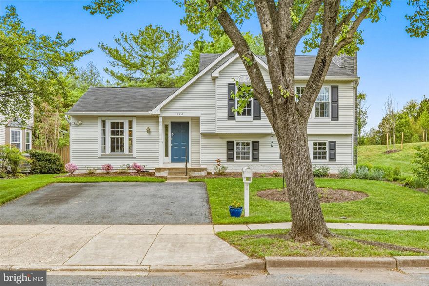 Charm and whimsy abound at this adorable 4 floor split level home, with NO HOA and energy efficient leased solar panels!  Entry brings you to a storage nook and an open living room with vaulted ceiling, lovely natural light, and hardwood floors.  The bright open window in front is perfect for your plants or furry friend to enjoy!  The seller took care to update the kitchen with new cabinetry, countertops, appliances and adding storage.  Doing the dishes isn't so bad when you have a view into the pretty backyard!  Adjoining dining area opens to the back deck, great for summer grilling days!  Lower level is a large family room with a wood burning fireplace and built-in shelving, perfect for cozy nights together.  The large space can be split up into a game area, entertainment space with tv, office space, workout area etc.  A full bath is tucked back so no one has to run upstairs in the middle of a good movie!  Mudroom on this level can be storage, or a space to walk out to the backyard. 
Upstairs you'll find three nicely sized bedrooms, two with hardwood flooring matching the hall and the primary with carpet.  The primary is on the back of the home, which provides privacy, and a large walk in closet!  Full bath on this level serves all three bedrooms and linen closets  makes for easy storage! Unfinished basement provides tons more storage too and houses the laundry. 
Adjacent to parkland, on a corner lot, there is a fully fenced backyard with beautiful plantings and lush greenery, right in time for summer!  New hot water heater installed in 2025, chimney inspected and repaired with fireplace in 2025, kitchen revamped in 2024, HVAC 2021.  Move in ready in a great location close to eats, shopping, entertainment, the new library and easy commuting!