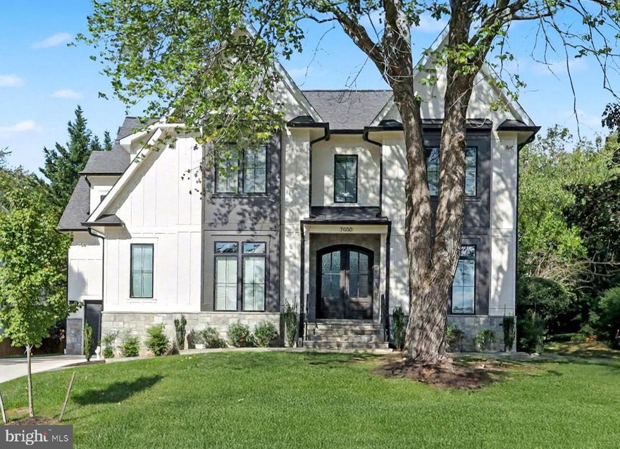 Discover 7000 Hector Road, a standout luxury home featuring over 7,500+ finished square feet, crafted by renowned builder Randhawa Inc. in McLean’s prestigious Broyhill-Langley Estates. This six-bedroom, seven-bath masterpiece seamlessly blends timeless architecture with modern comforts, exemplifying refined living in one of Northern Virginia’s premier neighborhoods. Set on a private, landscaped lot, this home offers custom elegance and tranquility. A flagstone walkway and double 8’ arched mahogany doors create a striking impression. Inside, 10’ ceilings, arched openings, custom woodwork, and wide-plank oak floors add sophistication. The main level features expansive living and dining spaces with ideal flow for daily use and entertaining. The chef’s kitchen features floor-to-ceiling cabinetry, a quartz waterfall island, a Sub-Zero 48” refrigerator, a Wolf 48” gas range with pot filler, and Brizo fixtures. A sunlit breakfast room opens to a private screened deck overlooking the backyard, accessible from both the breakfast room and the family room. The pass-through window from the screened deck connects to the wet bar with a Sub-Zero wine cooler. The adjacent family room features a coffered ceiling and a gas fireplace with a marble surround. Additional main-level highlights include a stylish powder room with herringbone marble floors and champagne bronze fixtures, an oversized mudroom with custom built-ins and a wash station designed for pets or outdoor gear, and a formal living room with an impressive feature wall that currently serves as a sophisticated office and sitting room. Upstairs, five ensuite bedrooms extend from a central family lounge. The owner’s suite features two custom walk-in closets, a gas fireplace, and a spa-like bathroom with heated flooring,  a contemporary wet room with a freestanding tub, and an oversized shower. Each bedroom and bath features custom closets, luxury tile, and designer fixtures. The finished lower level expands the living space with a large recreation room, a full wet bar featuring a marble island and a full-size refrigerator, a dedicated exercise room, an expansive media room, and a private guest suite. A three-car garage (split 2-car and 1-car bays), flexible living areas, and thoughtful circulation enhance daily convenience. Light streams through well-placed windows, and carefully chosen architectural details and fixtures showcase luxury throughout. Ideally located near downtown McLean, the McLean Community Center, the library, major commuter routes, and both top-ranked public (Churchill/Cooper/Langley) and private schools, this residence offers exceptional access without compromising privacy. 7000 Hector Road is a rare offering. It is a truly distinguished residence, providing privacy, craftsmanship, and luxury at every turn in one of McLean’s finest settings.