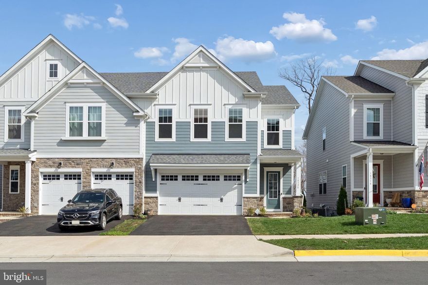 Watch the beautiful sunrise and waterfront views in your living room! Rare opportunity in fabulous Potomac Shores! This stunning, better-than-new villa is only two years young and boasts over 3,100 square feet of finished living space that feels like a single-family oasis. (Will upload  video tour shortly, stay tuned!)

No more stairs from the garage to your kitchen and living room! Seamless living at Potomac Shores means breathtaking views, a great backyard, and unmatched privacy. Why pay $700K for a townhouse when you can live in the lovely 5-bedroom and 3.5 bath home with amenities for just a few hundred dollars more in monthly mortgage?! 

The main living area welcomes a spacious 2-car garage, mud room, and powder room tucked behind the kitchen. The gourmet kitchen is truly an at-home chef’s dream with a large island, walk-in pantry, and an electric cooktop with a pre-plumbed gas line. Easily switch out for a gas cooking experience if the new homeowner prefers! From the kitchen, venture into the well-lit living room with welcoming oversized windows overlooking the private backyard and Potomac River! Enjoy a beautiful view in all four seasons!

Upstairs, the primary bedroom features a spacious ensuite bath (tub and shower!) and a large walk-in closet. Three additional bedrooms share a hallway bath with a double vanity. The laundry room is also on this level, adding to the unmatched convenience of this home. Downstairs, you’ll find a walkout basement with a fifth bedroom, a full bathroom, a storage room and utility room. This space truly operates as a retreat and could easily be transformed into an in-law suite or at-home office space. 

Finally, enjoy resort-style living with access to pools, fitness centers, a golf course, and scenic trails, all within the vibrant Potomac Shores community. Ideally located for commuters, this home offers convenient access to the new VRE station and is just five minutes from Route 1 and I-95. Don't wait! You do not want to miss this house!