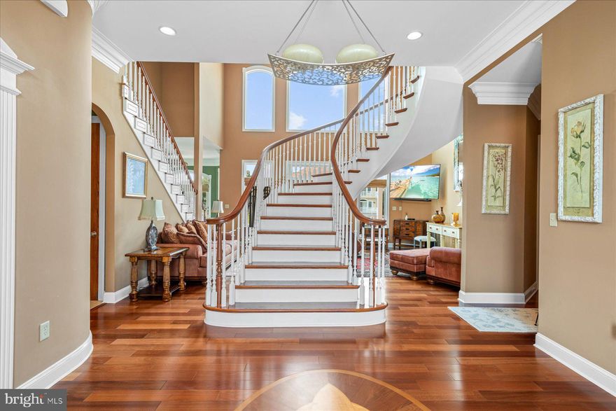 This exquisitely designed home is the total expression of resort style living. It is positioned flawlessly on a 90' coastal lot. The showplace professional open kitchen is the center of this home with multiple entertaining spaces. Distinguished design choices and attention to details are prevalent throughout. Sundrenched decks add to the appeal of this home. Special features include a fully equipped dock with a Golden top mounted 16,000lb boat lift and two swivel PWC lifts complete the ultimate outdoor pleasure. Lasting memories will undeniably be created enjoying this tranquil oasis.