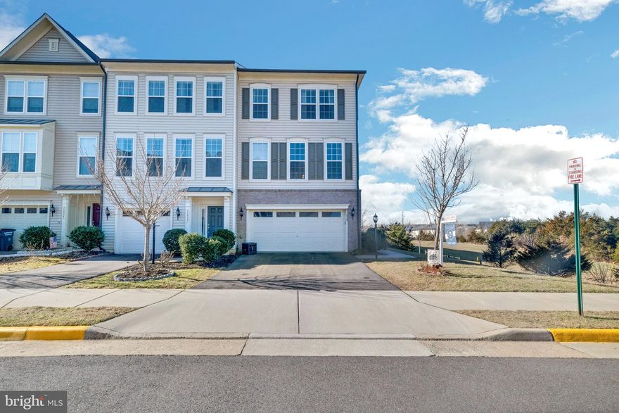 Welcome home to this gorgeous 3 level End of Row townhome in sought after Victory Lakes in Pembrooke! Walk up to a light and bright main floor that features an open space living area with wood-like floors that flow throughout. Anchoring the level is the kitchen with a stunning 11 ft floating waterfall island with seating for 4, deep sink with detachable faucet, plus ambient pendant lighting. The kitchen also includes crisp white cabinets, quartz countertops, and all stainless steel appliances including a triple door fridge and gas oven. The living room features recessed lighting, cooling ceiling fan, and a cozy fireplace with mantel. Easy access to your open air deck from the sliding glass doors - the perfect place to entertain in warmer weather! Entertain guests easily in the formal dining room that features a centered 5 light chandelier and corner windows. Half bath completes the level. Take the stairs to the third floor and main bedroom suite that features a tray ceiling, cooling ceiling fan, spacious walk in closet, and two walls with window views, including  one with a built in ledge/window seating! Also features an en-suite bathroom with dual vanity, tiled stall shower with luxury rain showerhead and toilet closet. Two additional bedrooms both with cooling ceiling fans, plus a hall bath with tub/shower combo completes the level. The entire upper floor has new luxury vinyl flooring ('20). The ground level includes new laminate flooring, recessed lighting, and features shiplap walls at the entrance plus a stunning barn door that separates an additional room making for the perfect home office or guest suite! A full bath completes the level. Easy access to the fully fenced in backyard from the sliding glass door - the perfect place to relax at the end of the day! Plenty of parking with the attached two car garage and paved driveway. Recent updates include Roof ('18) with life time warranty and Trex Deck ('16). Victory Lakes is an active community with outdoor pools, tot lots, tennis/basketball/volleyball courts, scenic trails, and even an enclosed park for your favorite Dog. (VL is zoned for Patriot HS.) Convenient to major transportation routes, including 66 and the Prince William County Parkway, plus only a few miles to the VRE. There are plenty of shopping & restaurant options nearby including the popular 2 Silos Brewery, and several wineries. Don't miss this one!