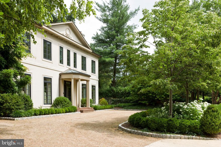 This elegant Regency Style residence was built c1994, in the restrained style of French pavilions, as seen in Jerome Zerbe's classic tome "Les Pavillons - French Pavilions of the Eighteenth Century". 
The property is situated in the leafy Northwest neighborhood of Kent, adjacent to & overlooking Glover Archbold Park. The present character of the house is a collaboration among the owners talented 
architect George Stavropoulos, the refined style of Washington DC interior designer Frank Babb Randolph, and the sophistication of the owners themselves. Working together they have created a stylish environment as a refuge from a constantly busy world. 
The residence is approximately 5,805 sq ft(per tax record)  of living space, with a lot size of 13,236 sq ft & consists of three finished floors with light pouring in from the East & West. The interior is traditional in floor plan, with high ceilings & is conducive for gracious entertaining, with ease of movement for today’s lifestyle. The wide Entrance Hall/Stair Hall is flanked by the Living & Dining Rooms, opposite each other, & continues full length to the Country Kitchen/Family Room, with Dining area, across the rear of the house. Light drenched, this area opens to the Balcony & Deck for outdoor dining and staircase to the lower gardens & patio.  
The upper  floor includes a spacious Primary Bedroom with full Bath en-suite with  an adjacent Sitting Room, & two large corner bedrooms with baths en-suite. 
The Lower floor, also with high ceilings & full height doors/windows, opens to  the rear patio/garden
 & consists of a second Family Room custom paneled in Pecky Cypress with plenty of bookshelves, a
 Music Room , walk-in Wine Room,  & Guest Bedroom, with full Bath en-suite.
 Adjacent is a spacious Gym with a full bath, including a steam shower. 
The Lower level additionally has Laundry & Mechanical rooms.
A double Garage is front loading from the street & motor court.
The exterior of the property has luxurious, professionally designed landscaping. 
Truly an exceptional property.