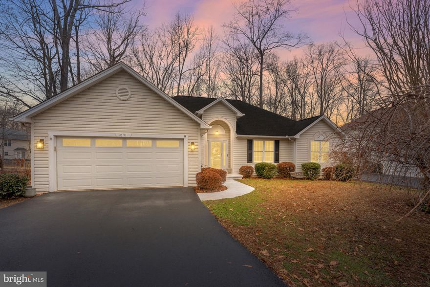 Charming one-level living in the highly sought-after Lee’s Hill community!Mature landscaping creates welcoming curb appeal, and the inviting foyer opens to warm wood floors and cathedral ceilings that enhance the light-filled, airy feel throughout.
The cozy family room features a fireplace with an expansive mantel—perfect for gathering or enjoying a quiet evening at home. The thoughtfully designed kitchen offers updated cabinetry, wood flooring, a stainless steel gas range, pantry, and a convenient laundry area just off the kitchen. The 2021 washer and dryer convey. An eat-in kitchen flows seamlessly into the dining area, creating an ideal layout for both everyday living and entertaining.
Just off the kitchen, you’ll find an enclosed porch as well as an open deck ideal for grilling or soaking up the sunshine.
In addition, a fully climatized four-season sunroom offers year-round comfort and wooded views that create a sense of privacy to enjoy morning coffee, quiet reading time, or simply unwind while feeling connected to nature. This versatile space adds valuable additional living space.
This beautifully maintained and thoughtfully updated home offers three bedrooms, including a spacious primary suite with an en-suite bath, walk-in closet, and custom closet system.
Major updates provide peace of mind, including a roof replaced in 2010, exterior HVAC unit replaced in 2025, and a tankless hot water heater for energy-efficient comfort. A large crawl space offers excellent dry storage for seasonal items and organization.
The generous two-car garage provides ample room for vehicles plus additional storage and features a dedicated workspace area with a built-in workbench already in place—ideal for projects, tools, or hobbies.
Fantastic location near medical facilities, shopping, dining, downtown Fredericksburg, and the Virginia Railway Express (VRE) for convenient commuting options.
A wonderful opportunity for easy, low-maintenance living in one of the area’s most established and desirable communities.