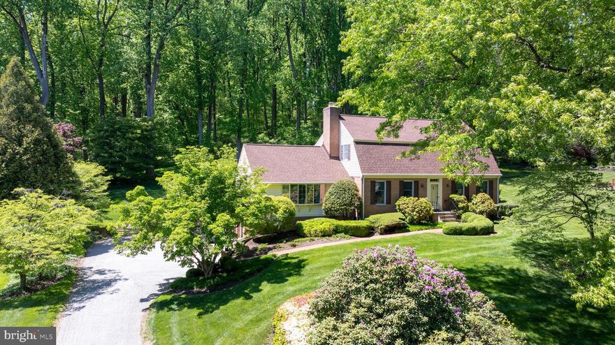 Buyers often wait and watch patiently for an opportunity to own in Manor Woods, one of Glen Arm’s  classic & treasured neighborhoods. Perched on a beautifully landscaped one-acre lot toward the end of a quiet no-through street, this stately four-bedroom, three full bath Dutch Colonial offers timeless architecture, generous living spaces, and a serene setting that feels private while still maintaining a warm “neighborhood feel.” Inside, gorgeous hardwood floors, crown molding, wainscoting, fresh paint, new carpeting, and a gracious center hall foyer create a warm and welcoming first impression. A brick walkway and brick retaining wall add to the home’s classic curb appeal. The spacious living room and elegant dining room are full of natural light and ideal for both everyday living and entertaining, while the expansive family room features beamed ceilings, rich paneled walls, a striking brick wood-burning fireplace with mantel, and French door access to the beautiful brick patio, stone paver walkway, and lovely backyard setting. The large kitchen is ready to enjoy as-is with ample space to personalize over time, offering exceptional functionality, featuring room for a table, built-ins, abundant cabinetry, double wall oven, stunning range hood, and a window above the sink overlooking the backyard green space and trees. A bonus main level bedroom, currently used as an office, sits adjacent to the main level full bath and offers flexibility for guests, multigenerational living, or work-from-home needs. Upstairs, you’ll find a generous primary suite that includes a private bath and custom walk-in closet, while the hallway leads to your third full bathroom, recently updated,  and two additional spacious bedrooms. The unfinished lower level with laundry has impressive ceiling height and endless potential for future living space, recreation areas, fitness rooms, storage, or workshop space. Recent improvements (2021-2022) include new roof, siding, gutter system, water heater, bathroom updates, as well as fresh paint, new carpeting, and a newer A/C (2019). A two-car side-entry garage and expansive driveway provide ample parking for family and guests alike. Manor Woods is located just moments from Loch Raven Reservoir, known for its scenic surroundings, hiking trails, water views, and natural beauty while remaining convenient to everyday amenities – just 15–20 minutes to Towson with quick and easy access to 695 and I-95. Book your showing today and take advantage of this rare opportunity to make Manor Woods “home.”