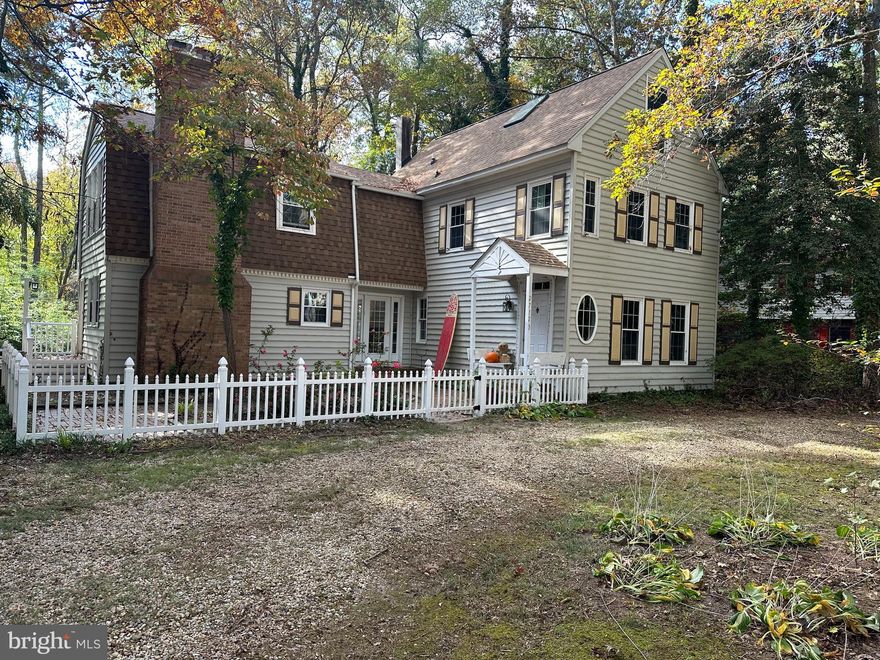 THIS BEAUTIFUL HOME IS BACK ON THE MARKET AFTER SOME GENERAL MAINTENANCE AND BEAUTIFICATION!  Charming and full of character, this custom built home was designed by an architect to reflect the colonial period with all of its glory!  Nestled in the desirable Crooked Oak Estates, this home features 3 bedrooms,  2.5 baths, and more than 21oo sq. ft. of living space.  This home boasts some truly unique features, including original barn doors, wide-planked hardwood floors, dual staircases, 4 fireplaces, and an efficient wood burning stove.  Enter this home from a welcoming courtyard area into a central foyer, where you can look out onto a back deck and ultimately to the natural wooded area beyond the back yard.  On one side of the foyer, you'll find the formal dining room complete with custom built-ins, and a formal living room with gas fireplace and custom trim and mouldings in addition to more custom built ins.  Off the foyer toward the other side of the home, you'll find the kitchen with all of its charm and character such as exposed wood beams, brick accents, and a barn door pantry.  A breakfast area off includes an oversize masonry fireplace on one end, and a one of two staircases at the other end.   Upstairs includes 3 spacious bedrooms, 2 on one side, each with a wood burning fireplace and custom built ins and a shared bath.  On the other side of the hallway you'll find a primary bedroom suite with high ceilings, ample closet space, and an ensuite bathroom.  Off the primary bedroom is a staircase leading to a completely finished bonus room, which could be used for a huge overflow guest room with skylights allowing natural light to flood the space.  The main stairway leads back downstairs to the front entry.