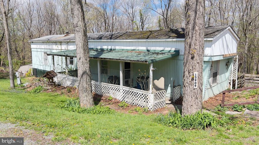 PRICED TO SELL.  This mobile home situated on a RENTED LOT (No real property conveys).  Features 2 bedrooms and 2 baths, covered front porch area.  The roof is a PITCHED shingle roof.  There is a small addition on the back for storage.  Previous owner had a wood stove there not sure of condition.  This one is priced to sell.  Mobile can not be moved from the lot per the seller.  Current lot rent is $425.00 per month plus $100 for water, sewer and trash pickup.  This is not a rent to own or owner finance.  Most likely cash will be needed to purchase.