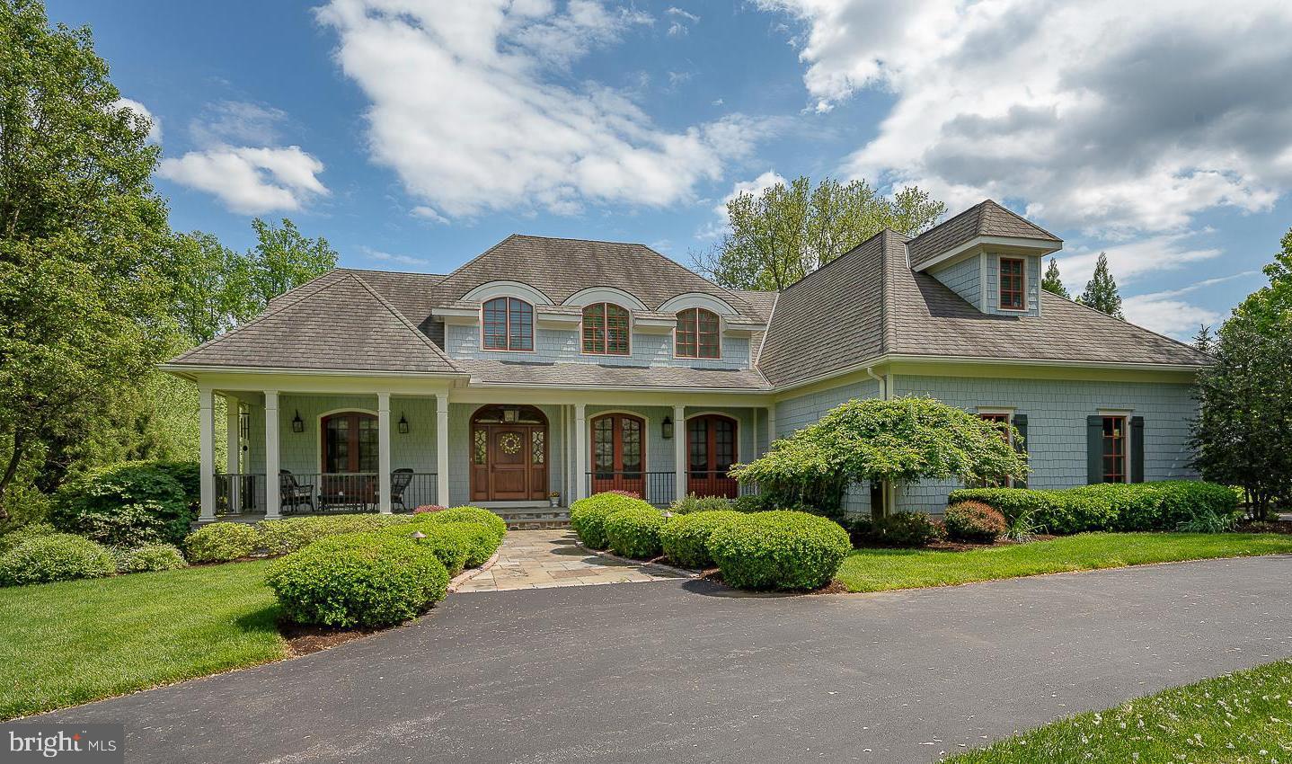 Nestled on a spectacular 1.425-acre professionally landscaped lot in the coveted Echo Valley neighborhood, 4104 Meadow Lane was custom built in 2008 and thoughtfully designed by Rene Hoffman of RA Hoffman Architects with James Hardie shingles and graceful curved windows. This five-bedroom, four-and-a-half-bathroom home exudes timeless elegance and meticulous craftsmanship, both inside and out.
A sweeping semi-circular driveway welcomes you, leading to a charming stone and flagstone front porch—an ideal place to relax and take in the peaceful surroundings. Inside, a gracious Foyer sets the tone with deep crown molding, 10ft high ceilings and sight-finished hardwood floors that flow through most of the home. To the right of the foyer, the formal Dining Room features a tray ceiling and two arched French doors that open to the front porch. To the left, glass-paned french doors lead to a richly appointed Home Office with a coffered ceiling, custom built-ins with a window seat and an arched French door to the covered front porch. The foyer leads to a central hall with sweeping staircase and opens to the stunning Living Room with vaulted ceiling with beams and trusses and a floor to ceiling stone fireplace flanked by arch topped French doors leading to the Sunroom with skylights, radiant heat floors and doors out to the flagstone patio and private backyard with beautiful garden beds.
At the heart of the home is the gourmet Kitchen, a chef’s dream showcasing inset cabinetry with under cabinet lighting and an oversized island lit by stunning orb pendant lights. The appliances include a Sub-Zero wood paneled refrigerator, two Sub-Zero refrigerator drawers, 2 wood paneled Bosch dishwashers, and a suite of Thermador appliances; 5 burner hybrid induction cooktop, two wall ovens, a built-in microwave and warming drawer. A stunning custom wood hood and elegant dark granite countertops with two undermount stainless sinks, two appliance garage cabinets and pantry cabinets complete this space. The kitchen opens to the Breakfast Room and spacious Family Room with vaulted ceiling, gas fireplace, and built-in cabinetry.
The serene, first floor Primary Suite offers a tranquil retreat with a sitting area, two walk-in outfitted closets and the luxurious en suite Bathroom featuring radiant heat floors, soaking tub, oversized shower with bench, private water closet, and dual vanities with built-in cabinetry towers. The Laundry Room boasts cabinetry, a sink and folding counter with a window above providing natural daylight.
Upstairs, three additional Bedrooms feature charming architectural details, hardwood floors and custom outfitted closets. They are serviced by two well-appointed full bathrooms one with double sink vanity and tub shower combination and the second with both a tub and glass enclosed shower. Custom built in bookshelves in the hallway and a bonus room that provides flexibility as an office, an art studio or a guest room complete this level.
The finished Lower Level is complete with a built-in wet bar with beverage refrigerator, a gym area with wall mounted TV, and an Indoor Endless Pool. A fifth Bedroom with double closets and a full Bathroom with an oversized shower provide a comfortable space for guests. Additional highlights include a Mudroom with a family entrance and built-in lockers, a Powder Room, elevator access to the main and lower levels, and an oversized three-car Garage with custom storage by Garage Tek. The heat and air conditioning zoned per floor, whole house Generator, and on demand hot water heaters provide all the modern conveniences for today's lifestyle.
Enjoy peaceful mornings on the front porch, cozy afternoons in the radiant-heated sunroom, or gatherings on the slate patio overlooking the professionally landscaped backyard. Positioned in a great location, this home is just minutes from Newtown Square with its many restaurants and shops.