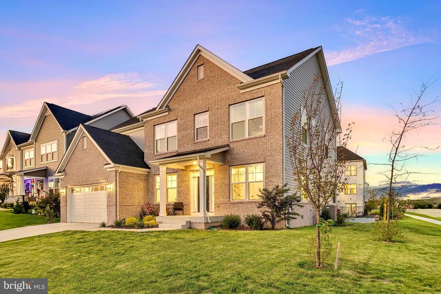 Welcome to 428 Meadow Creek Drive, an exquisite Albemarle in Bowie’s vibrant South Lake community—where everyday living feels a little more like resort life. From the moment you step inside, sunlight and volume set the tone: wide-plank floors, clean lines, and designer finishes connect an open kitchen, morning room, and fireside family room that were made for gathering.

At the heart of the home, the chef’s kitchen blends beauty and performance—sleek Carrara-look quartz, an apron-front sink, Manchester White cabinetry with matte-black pulls, a sprawling entertainment island, gas cooking, and Whirlpool “Master Chef” appliances. Pendant lighting floats over the island while recessed LEDs keep everything bright and workable. Just beyond, the window-wrapped morning room spills onto a newly built deck, which steps down to a custom patio and built-in fire pit—weeknight
s’mores and fall tailgates, handled.

The main level also delivers true flexibility with a private in-law/guest suite and its own full bath—ideal for multi-generational living, long-term guests, or a quiet office with a door you can close.

Upstairs, the home’s calm continues with three secondary bedrooms and a serene owner’s retreat. This is where you’ll exhale: a generous bedroom with a separate sitting area, an enormous walk-in closet with space for a dressing chair, and a spa-style bath featuring a Roman shower with frameless glass and on-trend matte-black finishes.

The finished lower level opens up even more possibilities—a large recreation room for movie nights or a gym, plus a flexible guest suite/den with an adjacent full bath. A full walk-up areaway brings in extra light and easy access to the backyard.

Thoughtful upgrades elevate daily living throughout: boxed oak stairs with white risers and balusters, coordinated matte-black door hardware, dimmers where you want them, eight ceiling-fan prewires, structured networking, a smart-home hub with video doorbell and connected garage, and an EV-ready 240V outlet in the garage. The brick-front elevation and upgraded exterior details refine the curb appeal before you even walk in.

Life at South Lake means having green space and future fun built in. The community plan anticipates a clubhouse with pool, patio and fire pit, playgrounds, asphalt trails with fitness stations, and beautifully maintained common areas. And with quick access to DC, Annapolis, and Fort Meade, the commute is as effortless as the weekends.Move-in ready, meticulously upgraded, and crafted for connection—428 Meadow Creek makes “new” feel extraordinary.