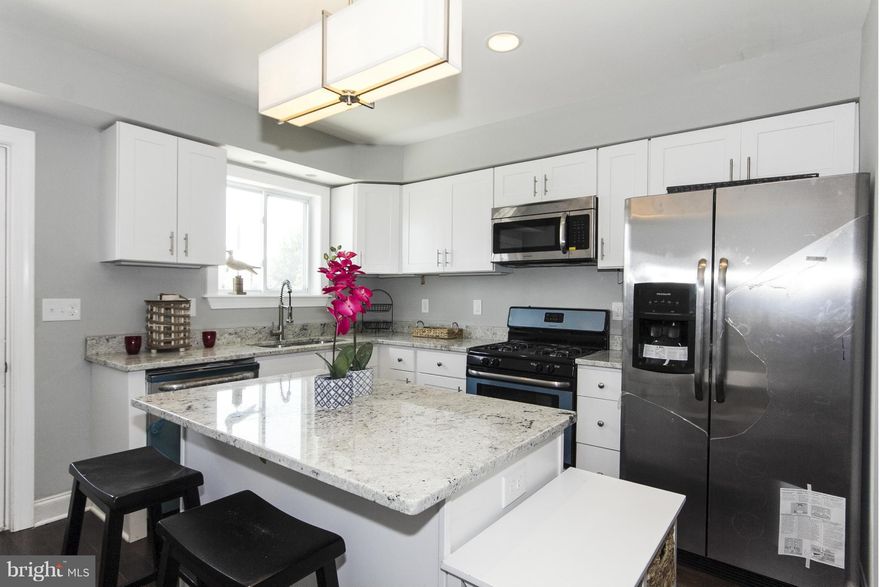 Locust Point.amazing custom row home! Large interior unit,14' wide.*Tx record incorrect house is 1600 sf!! Beautiful hardwood, gourmet kitchen with exotic granite and new SS appl. Custom Coffered Ceilings on main w/ amazing lighting. 2FB on 2nd level with custom tile and vanities & Two 1/2 baths!  Full basement for storage or xtra rooms. Large parking pad in rear. 2 rooftop decks! THIS IS THE ONE!