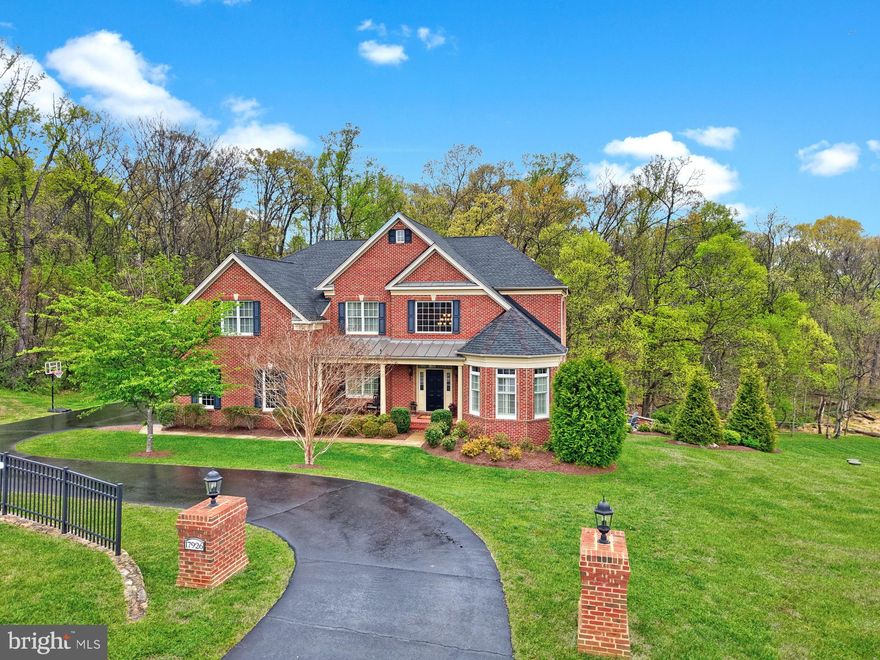 Welcome home to 17926 Skip Away Ct. Nestled on a picturesque and private 3-acre wooded homesite in a prestigious estate community, this stunning home offers the perfect blend of serene seclusion and everyday convenience just minutes from downtown Leesburg. This exceptional luxury residence features over 6,000 square feet of beautifully designed living space, including 5 bedrooms and 4.5 baths.  Thoughtfully crafted with a bright open-concept layout, the home showcases soaring ceilings and expansive windows that fill the space with natural light. The spacious gourmet kitchen features a large island, classic white cabinets, granite counters and stainless appliances.  Flows seamlessly into the inviting two story family room with a floor to ceiling stone fireplace and large picture windows. Rounding out this level is a formal dining room with a tray ceiling, a spacious living room, a private office, and a versatile front den or playroom highlighted by charming rounded windows. A conveniently located laundry room and mudroom add to the home’s functionality and everyday ease. All of this creates an ideal setting for both everyday living and elegant entertaining. The upper level features four generously sized bedrooms, including an impressive primary suite with a tray ceiling accented by wood inlay. The suite also offers a private sitting room with a fireplace, a spacious en-suite bath with a soaking tub, separate walk-in shower, and dual vanities, as well as a large walk-in closet with built-in organization. Three additional bedrooms provide ample space, with one offering a private en-suite bath and the remaining two sharing a well-appointed bathroom. The lower level offers a versatile recreation room, perfect for entertaining or relaxing, along with a fifth bedroom featuring walk-out access to the patio. A full bathroom on this level adds convenience, making it an ideal space for guests or extended living. Step outside to enjoy the ultimate outdoor lifestyle with a large deck and patio complete with a fully equipped outdoor kitchen—perfect for hosting gatherings. Relax and unwind in the new hot tub while taking in peaceful wooded views, offering a true private retreat in one of Leesburg’s most desirable estate communities. Some recent updates include upper level hvac is 1 year young, new carpet in family room and bedroom level.  Hardwood is in the upper level hallway too. Mortgage savings may be available to buyers of this listing.