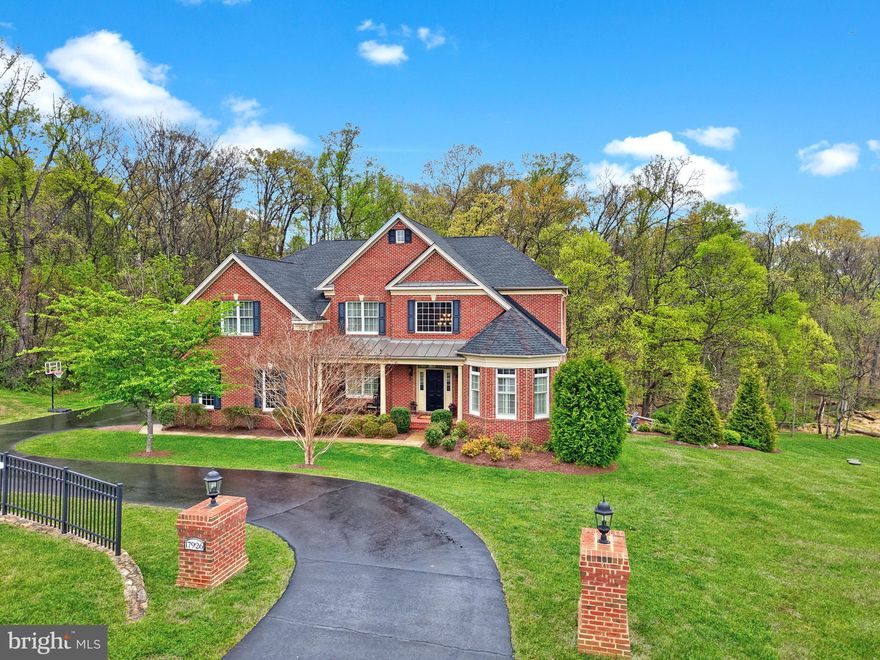 Welcome home to 17926 Skip Away Ct. Nestled on a picturesque and private 3-acre wooded homesite in a prestigious estate community, this stunning home offers the perfect blend of serene seclusion and everyday convenience just minutes from downtown Leesburg. This exceptional luxury residence features over 6,000 square feet of beautifully designed living space, including 5 bedrooms and 4.5 baths.  Thoughtfully crafted with a bright open-concept layout, the home showcases soaring ceilings and expansive windows that fill the space with natural light. The spacious gourmet kitchen features a large island, classic white cabinets, granite counters and stainless appliances.  Flows seamlessly into the inviting two story family room with a floor to ceiling stone fireplace and large picture windows. Rounding out this level is a formal dining room with a tray ceiling, a spacious living room, a private office, and a versatile front den or playroom highlighted by charming rounded windows. A conveniently located laundry room and mudroom add to the home’s functionality and everyday ease. All of this creates an ideal setting for both everyday living and elegant entertaining. The upper level features four generously sized bedrooms, including an impressive primary suite with a tray ceiling accented by wood inlay. The suite also offers a private sitting room with a fireplace, a spacious en-suite bath with a soaking tub, separate walk-in shower, and dual vanities, as well as a large walk-in closet with built-in organization. Three additional bedrooms provide ample space, with one offering a private en-suite bath and the remaining two sharing a well-appointed bathroom. The lower level offers a versatile recreation room, perfect for entertaining or relaxing, along with a fifth bedroom featuring walk-out access to the patio. A full bathroom on this level adds convenience, making it an ideal space for guests or extended living. Step outside to enjoy the ultimate outdoor lifestyle with a large deck and patio complete with a fully equipped outdoor kitchen—perfect for hosting gatherings. Relax and unwind in the new hot tub while taking in peaceful wooded views, offering a true private retreat in one of Leesburg’s most desirable estate communities. Some recent updates include upper level hvac is 1 year young, new carpet in family room and bedroom level.  Hardwood is in the upper level hallway too. Mortgage savings may be available to buyers of this listing.