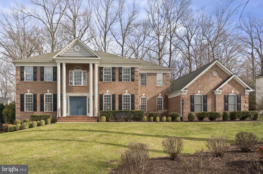 Welcome to 7880 English St. in the sought after Meadowbrook Woods community nestled in a convenient mid-county location w/ easy access to I-95, I-66, Fairfax, DC, VRE train, & major commuter routes. This home is a short drive to shopping & restaurants in the Historic City of Manassas, Town of Clifton, Woodbridge, Gainesville & several local Prince William and Fairfax County Parks. Meadowbrook Woods has an abundance of amenities and a vast community social calendar.  Living here you feel a great sense of community and pride of ownership, all within the highly sought after school tier of Marshall ES, Benton MS, and Colgan HS. This stately brick front colonial home is situated on a large .62 acre peaceful and private lot that backs to trees providing serenity and elegance.  You will be wowed from the moment you pull up to this magnificent home on a quiet cul-de-sac.  The gorgeous exterior with large pillared front porch and extensive landscaping will draw you in!  This home has a large 3 car side-load garage and a fenced in rear yard and an expansive rear deck.  The moment you step inside the double front doors you are welcomed in by a warm two-story staircase with a center hall foyer and gleaming hardwood floors throughout the entire main level!  The main level is an entertainers dream with an open concept gourmet kitchen that looks out into a large family room with vaulted ceilings and a cozy brick hearth with gas fireplace.  The main level has 9ft ceilings, an upgraded trim package with crown, shadow box and chair rail moldings, loads of recessed lights, as well as Palladian and Transom windows that allow an abundance of natural light into the home.  There is a large formal dining room, formal living room, and a library/sunroom with built-in bookcases and a wet bar for entertaining. The sunroom has two walls of windows allowing in natural light. The heart of the home, the massive kitchen, has space for a crowd and tons of storage.  Featuring 42-inch cherry cabinetry with undermount lighting, an elegant island with gas cooktop, Corian counter tops, double wall oven, all updated stainless-steel appliances, and a generous pantry.  It’s truly a chef’s dream!  The kitchen sink is surrounded by three bay windows looking out into the private back yard.  
The lower level is designed with more entertaining in mind!  There is a large bar area with ceramic tile floors, space for a large table or room to dance, a rec area with pool table that conveys, a secondary family room with a second gas fireplace, full windows allowing in natural light, and a walk-up basement. The lower level has a full bathroom & an enormous storage room. Sellers are conveying the pool table, pool light fixture, pool equipment, the bar with 6 barstools, bar fridge and microwave, the two TVs mounted on the walls in the basement, and three large storage racks in the storage area.
Up the two story wood staircase is the bedroom level with hardwood floors in the hallway and new carpet in all 4 bedrooms. There is a large primary suite with a gorgeous tray ceiling, a spacious sitting area, dedicated dressing area with built-in vanity and laundry chute, a large walk-in closet for two that includes a built-in wall safe!  The primary suite has a luxurious bath with a double jacuzzi tub, separate shower, linen closet and two sink vanities. The three secondary bedrooms are all generous in size with large closets, two of the back rear bedrooms have walk-in closets.  The hall bath allows for privacy with a door separating the toilet/tub from the large double sink vanity.  The whole home has been meticulously maintained and is in excellent condition.  HOA amenities include a club house- that can be reserved for parties and is equipped with a full kitchen, large outdoor pool, swim team,  playground, sports courts, pond, walking trails, open common areas,  trash and recycling pick up.  The driveway was recently replaced in 2023. Come see your dream home!