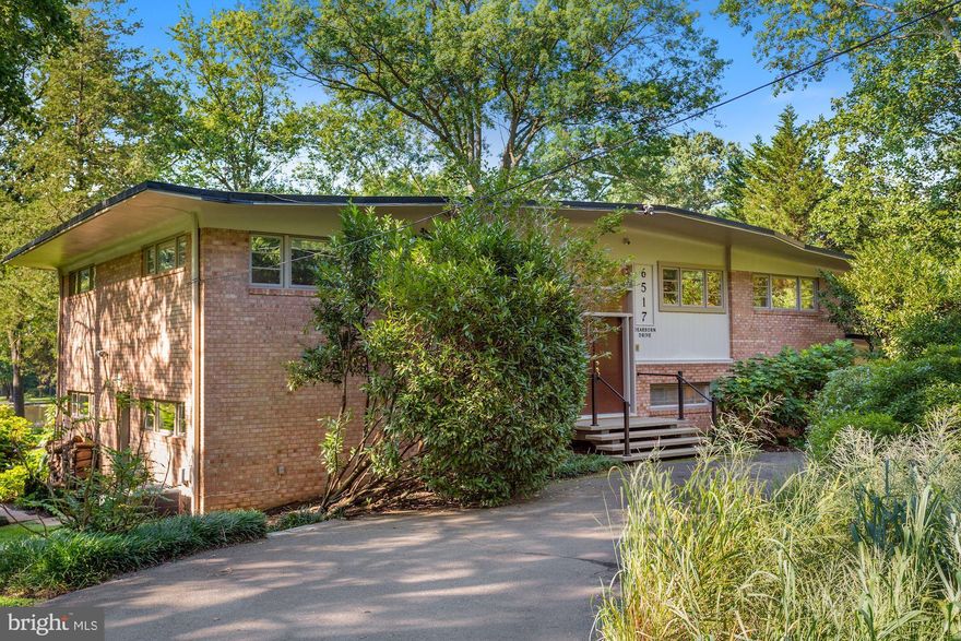 EXCITING LAKEFRONT OPPORTUNITY. Stunning mid-century contemporary nestled on nearly 4/5-acre of gorgeously landscaped gardens backing directly onto fabulous Lake Barcroft, with 115 feet of direct water frontage. Imaginative architectural design affords breathtaking year-round vistas of the lake from most rooms, beginning with the 26-foot living room, which boasts 16 feet of floor-to-ceiling glass doors leading to a delightful deck which overlooks the private garden and lakefront.

Breathtaking kitchen renovation includes separate sinks for cooking and dishwashing, high-end appliances, granite counters, a skylight, and gorgeous natural cherry cabinets

The interior of the house has just been freshly painted, and the hardwood floors on both the main and first lower level have been sanded and refinished. There are cathedral ceilings throughout the main level, and extensive use of recessed lighting throughout.

The top level includes the living and dining rooms, kitchen, owner's suite with private bath, a second bath off the hall, and a second bedroom presently used as an office with built in desk and cabinets. The first lower level includes a family room with fireplace and built-ins, and a delightful 31-foot garden room with three sets of double glass doors opening to the rear terrace, and also featuring brick walls, two ceiling fans, and a magnificent wet bar with small refrigerator, dishwasher and granite counters. There are also three additional bedrooms and a third full bath on this level.

The unfinished basement offer laundry and utility areas, and plenty of space for storage.
OPEN SUNDAY, AUGUST 29 1:00-4:00pm