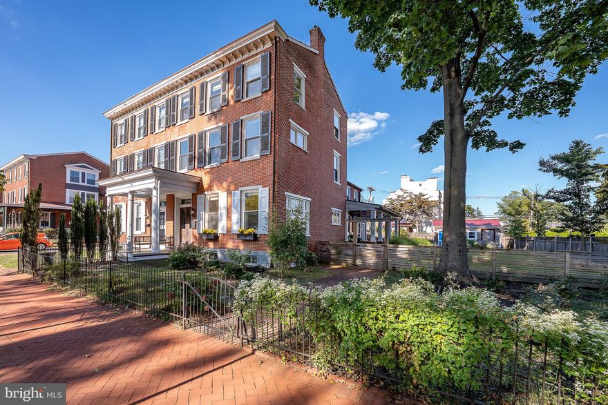 We invite you to walk back in time where elegance meet style to create this amazing three-story 3,366 sq ft home! 303 South Church Street is an historic home with fully renovated interior. Taken down to the studs in 2017 and fully renovated by Pine Street Carpenters. It is a classic Federal Style brick twin home, situated on a double fenced lot complete with multi-car parking and a garage off the alley all located within walking distance to everything that West Chester offers. Enter an elegant double entryway into the first floor with tall ceilings and lovely old world glass doors, windows and transoms. Breathe in the stories and history as you enter the living room with tall windows, wide plank white oak flooring (all from one tree!) and beautiful millwork. Transition into a large family room with a fireplace and a second recreation room with built-in book shelves. As you move to the heart of the home, there is a huge kitchen with soapstone counters, huge island with seating for five, Blue Star six-burner gas stove, two ovens, tile backsplash, deep porcelain sink, Blue Star refrigerator and fireplace. Each room is light and spacious with wonderful views of the large covered porch and gardens. The gardens were also fully renovated by Green Roots including drainage, irrigation, planting and lighting. Completing the first floor are: mud room, laundry room and powder room with tile flooring an an exit for a short walk to the garage and alley parking. The second floor hosts the primary bedroom with a beamed vaulted ceiling, huge organized walk-in closet, wonderful light and carpeted flooring. The en-suite bath has a double vanity, soapstone counters, tile flooring, large walk-in glass tile shower and cathedral ceiling. There are two additional large bedrooms with pine flooring, ceiling fans and ample closets and a hall bath with a trough sink for two, glass shower door and radiant heat tile flooring. The lovely architectural details, high ceilings, hardwood flooring and beautiful large windows extend throughout the second floor. The third floor has two additional rooms as well as attic space with ample storage. New electric, new plumbing, new HVAC (two zones, new ductwork throughout) and most windows are new. This home has been lovingly updated and cared for and will be an exceptional place to call home!