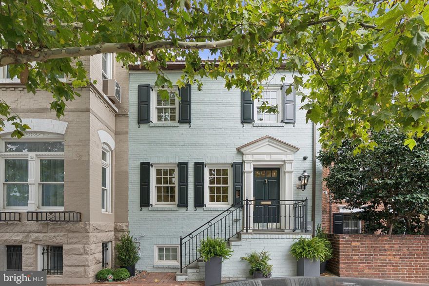 Beautifully redesigned and updated residence in Georgetown’s East Village neighborhood complete with luxe outdoor entertaining and enormous 2 car Garage with private guest quarters above, spanning nearly 4,000 SQFT altogether. This exceptional 3 Bedroom, 4.5 Bathroom residence was completely redesigned in 2022 with elegant easy city living in mind. Additional thoughtful renovations and upgrades have further transformed the home in recent years. Elegant finishes include custom millwork & cabinetry, Waterworks fixtures throughout, Duchateau European oak hardwood floors, Wolf / Miele top-of-the-line appliance package, Phillip Jefferies designer wall coverings, Calacatta marble, and Circa designer lighting. Recent updates include a fully integrated smart home system with advanced whole-house networking, security and audio systems, indoor and outdoor speakers, dimmers, new rear slate patio with stone edging, custom outdoor Kitchen featuring one gas and one charcoal grill, custom outdoor soft close cabinetry with granite countertop in a leathered finish, new outdoor lighting, irrigation system, professional landscaping, and EV charging port in Garage finished with new epoxy flooring. More recent updates include the added second washer/dryer, motorized & manual window treatments throughout, custom wool runner on staircases throughout and elegant glass shelving in the Lower-Level Wet Bar. No detail has been overlooked and no expense has been spared. This remarkable property seamlessly blends historic Georgetown charm with modern luxury, turnkey convenience and an extremely rare two car garage.