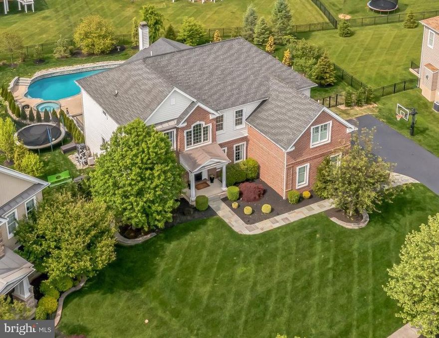 This Chester Springs beauty awaits its new steward. Pride of ownership is abundant throughout this showcase abode. From the moment you arrive, you will be impressed by the fantastic classic design and curb appeal and the exquisite updates throughout.  For the buyer seeking new construction without the headaches and expense- this may be the best VALUE in the area!   Step inside and you will be WOWED by the custom turned staircase and millwork, and the extensive gleaming wide plank hardwood floors. The soaring two story foyer is flanked by gracious entertainment sized dining room and living room The heart of the home will impress the most discriminating buyers - complete update and renovation of this gorgeous kitchen boasting furniture quality cabinetry, oversized island, commercial grade appliances, solid surface countertops, and beverage center and open to the soaring two-story family room with floor to ceiling stone fireplace.  From the breakfast area, access your own private oasis boasting custom hardscape with fireplace, seating areas and a large inground pool with hot tub.    An oversized walk-in pantry and a spacious  mudroom with custom cubbies adjoins  the attached three car garage . A private first-floor study completes this level.  At days end, retreat to the sumptuous master suite with his and hers walk in closets and sumptuous designer bath. The home offers a must have prince/princess en suite and two additional large bedrooms share a double vanity hall bath.  The daylight finished lower level includes an exercise room, full bath, wine cellar, and entertainment space with custom bar and built-ins. Situated within the highly sought Byers Station community offering two pools, clubhouse, playground, courts ;and close to shopping, restaurants, major roads and highways, Marsh Creek State Park- this home has it all! Don’t miss this treasured property (possibly the best VALUE in area) COMPARE!
