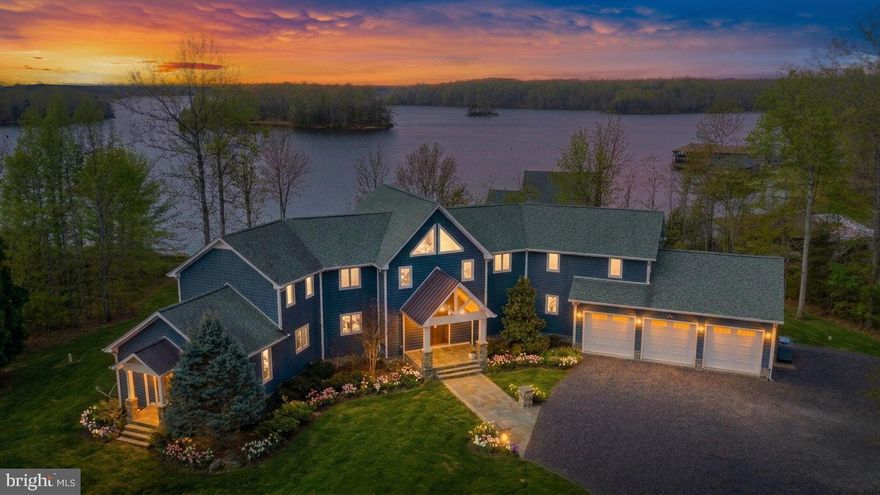 Experience lakefront living at its finest on the public side of Lake Anna with this stunning high-end luxury waterfront estate, perfectly positioned to capture expansive open-water views while being in a no-wake zone. Being sold turn-key and fully furnished, this exceptional property has high-speed Xfinity Comcast internet and is ready for you to start enjoying lake life immediately. Stone-bulkheaded shoreline, a sandy beach, and a private covered boathouse featuring two electric slips, a jet ski pad, partially covered sun deck, storage room, and tiki bar area, every detail has been designed for the ultimate waterfront lifestyle. The level backyard provides the perfect setting for corn hole, gatherings, and outdoor fun, while evenings can be spent around the fire pit or relaxing beneath the covered gazebo with an outdoor fireplace and grill. Inside, the home showcases quality craftsmanship and high-end finishes throughout. Nearly every room captures breathtaking lake views through a dramatic wall of glass windows beneath soaring vaulted ceilings. Brazilian cherry hardwood floors, granite countertops, and top-of-the-line Wolf appliances elevate the beautifully appointed kitchen. The home also features a full-size wet bar, private home office, theatre room, and home gym/game room, offering both luxury and fun.  Spanning over 4,700 finished square feet, the home includes four spacious bedroom suites, each with its own private bathroom. The luxurious primary suite offers vaulted ceilings, two walk-in closets, and a massive bathroom complete with a soaking tub, separate vanities, plantation blinds, and a tiled walk-in shower. The outdoor living spaces are equally impressive, with extensive hardscaping, exterior lighting, and lake-fed irrigation enhancing the beautifully maintained 1.36-acre cul-de-sac lot in the highly desirable Sycamore Shoals community. Enjoy the convenience of boating directly to nearby marinas and waterfront restaurants, making every day feel like a vacation. A truly remarkable waterfront estate where luxury, comfort, and lake life come together perfectly.