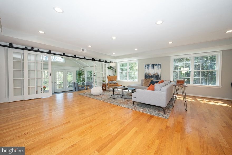 421 Wister Road is definitely not your typical brick colonial.  This very special home must be seen in person to be fully appreciated.  The 4-bedroom, 3.5-bath residence has been thoughtfully and beautifully transformed by its current owners with a stunning three-story addition, completed in 2016.  The result is an expansive, light-filled living space designed to seamlessly bring the outdoors in. The Family Room will exceed expectations, featuring white oak hardwood floors and walls of windows that flood the space with natural light.  Sliding French barn doors open to a breathtaking fully conditioned sunroom with a vaulted ceiling, Palladian window, tile flooring, and three walls of windows with easy access to the private deck and paver patio- perfect for enjoying the serene backyard. The spacious eat-in kitchen is ideal for both everyday living and entertaining, offering a long center island with seating for 3-4, space for an additional table, double ovens, a separate 5-burner Bosch cooktop with retractable vent, pantry, granite countertops, radiant heated floor, and abundant cabinetry. The formal dining room showcases a fireplace with wood-burning stove insert, while the den provides the perfect retreat for relaxation. A cheerful mudroom with a window bench leads to the driveway and small covered side deck- especially convenient in inclement weather. The primary suite, part of the addition, features two custom outfitted walk-in closets and a spa-like bathroom complete with a BainUltra freestanding air tub, custom double vanity and an oversized frameless glass shower.  A well-appointed Laundry Room featuring checkerboard tile flooring, fulll size washer and dryer, sink and cabinetry is just off the primary suite.  Three additional spacious bedrooms, one an ensuite, all with deep closets, and a full hall bath complete the second floor. Two staircases provide access to the lower level, which includes a finished Bonus Room, unfinished storage room and direct entry to the integral two-car garage and additional storage room.  The large level fenced backyard is truly exceptional - a wildlife haven, private and peaceful with a mature garden featuring an array of perennial edible plants. The best of all worlds...perfect, quiet location in Lower Merion Township, in a walkable neighborhood minutes to shopping, schools and restaurants as well as to downtown Philadelphia, 30th Street Station and Philadelphia International Airport.  You won't want to miss this very special opportunity!