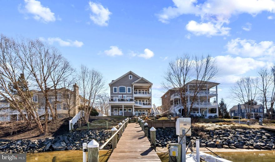 ***NO FLOOD INSURANCE REQUIRED***  Explore the beauty of the waterways from Norman Creek to the scenic Chesapeake Bay!  Whether you are boating, fishing, or simply embracing the serene creekfront ambiance, this property truly embodies the ultimate coastal lifestyle. Don’t miss this rare chance to secure a piece of waterfront paradise on a unique peninsula, surrounded mostly by new construction and picturesque woodlands. This custom-built 3-story, 10-year-old, 4,900 sq. ft. retreat, situated on an elevated 0.25-acre lot, does not require flood insurance! This remarkable home is designed with both entertaining and relaxation in mind. From every balcony, you will be greeted by breathtaking water views, enhanced by 8-foot doors and 6-Foot windows that invite natural light into every corner of the house. Each level features charming covered porches/decks, and the front facade offers 2 balconies and a porch, making entertaining a pleasure—whether on or off the water! Professional boaters will enjoy the 120-foot marine-grade lumber pier equipped with electric power, de-icers, 2 boat lifts, a jet ski lift, a Sun deck, and a floating dock for two jet skis. The beginning of the pier is surrounded by a Rip Rap bulkhead.
As you step inside, you will appreciate the open design with 9Ft ceilings throughout. The 2nd Floor living level offers a breathtaking 2-Story coffered ceiling in the family room, showcasing a stone gas fireplace surrounded by transoms and architecturally designed windows-what a view!. The “heart of the home”? A magazine-worthy professional kitchen with cherry cabinetry, gleaming granite countertops, and Kitchenaid stainless steel appliances! Gleaming Hardwood on the 2nd and 3rd Floors....Manufactured laminate hardwood on the 1st level.  Every space feels intentional and elevated, offering a primary suite on the first level, another on the third level; four total bedrooms, each equipped with an ensuite bath.  The ground Floor has a LL Family and Half Bath as well. Want to host a wedding or New Year’s Eve party?  No problem with a wet bar on each level of the home! It’s a lifestyle, waterfront living re-defined. Opportunities like this don't float by twice- your boat belongs here!    Included in a long list of upgraded options are a 50 Year Shingle Roof, Cat 6 wiring throughout, Hardwood staircases with single-basket wrought-iron balusters, 2 laundry rooms, 2-zone heating with Propane backup controlled by separate thermostats on each floor! 21x21 two-car attached garage, a paver-stone driveway, a hot-tub deck, and much more.  The address number in the MLS listing map and Google Maps is incorrect (it says 428). The Pin in the MLS Map is correct for 424 Katherine. Please see our features and amenities list in the disclosures.  Professional photos, video, and drone photos coming soon!