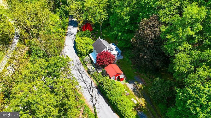 Welcome to this stunning property located at 62 Hein Rd, Lenhartsville, PA! Nestled on almost 4 acres of huntable land with a serene stream running through it and mature landscaping, this property is a nature lover's dream. The home features 2-3 spacious bedrooms, with a possible 4th in attic, and beautiful hardwood plank flooring, tile, and carpet throughout. Large full bath with claw-foot tub upstairs, and another full bath in the lower level with a large shower. The open great room is perfect for entertaining, and the maple kitchen cabinets add a touch of elegance to the space. Huge pantry for all of your kitchen and serving items.  Outside, you'll find a bank barn and a large utility shed, providing ample storage and versatility for all your needs.  Enjoy the large patio and fire pit for summer barbecues. The state-of-the-art septic system ensures peace of mind for years to come. Close to I-78, Route 222, and major cities. Don't miss the opportunity to own this exceptional property in a tranquil setting.  Schedule your showing today.