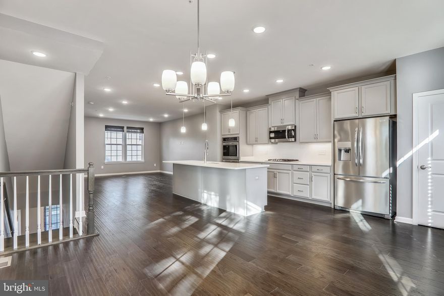 Offers Due on Monday July 12th at 6 PM.  This spectacular End Unit Townhome is one of the best offerings in the Metro Pointe community! It looks beautiful and won't last long! This Gorgeous three level home has 4 bedrooms and 4 bathrooms! This home is a Perry design with a lot of upgrades. The Entry level has a rear facing two car garage, one Bedroom and a half bathroom. The main level has wood flooring throughout the entire kitchen, dining area, living room and the powder room. The beautiful Gourmet kitchen has 42" gray cabinets and quartz countertops, sprawling center island, 6-burner gas stove, and stainless steel appliances. Dining area walks out to the rear deck. Upper level has a master bedroom with a large walk-in closet and master bath with double vanity sink and decorative upgraded shower tile. There are two additional bedrooms with a full bathroom. This house is just like new! Walk to the Landover Metro (Orange Line) for a quick commute. Metro Pointe is just minutes from Woodmore Town Center, with Wegmans, Best Buy, Chipotle, Costco, Old Navy, and more. Live close to recreational outlets, including FedEx Field and Prince George's Sports and Learning Complex.