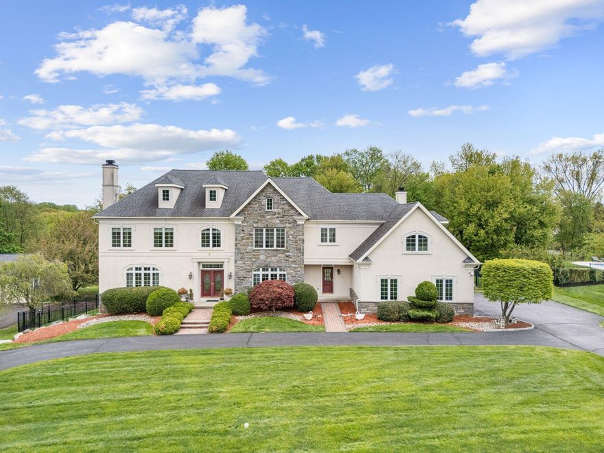 Welcome to this beautifully appointed five bedroom ( plus finished attic for use as a bed room or bonus space) 5 full and two half bath stone and stucco residence, where timeless architecture meets modern comfort. From its stately curb appeal to its thoughtfully designed interior, this home offers an exceptional living experience in one of the area’s most desirable settings.
A grand entry with marble floors and an impressive staircase sets the tone, leading to light-filled living spaces enhanced by rich hardwood flooring throughout the living room, dining room, family room, entrance hall, and first-floor study. Classic white walls and elegant architectural details create a refined yet inviting atmosphere, while the flowing floor plan is ideal for both everyday living and entertaining.
At the heart of the home, the kitchen features 42-inch cabinetry, stainless steel appliances, granite countertops, and a butler’s pantry, seamlessly connecting to an inviting family room anchored by a stunning floor-to-ceiling stone fireplace. Sliding doors lead to a four-season sunroom overlooking a private fenced lot with a tranquil koi pond, offering a perfect extension of the living space.
The primary suite offers a private retreat, complete with a serene atmosphere and ample space to unwind. Additional bedrooms are generously sized and versatile, easily accommodating guests, home office needs, or growing households.
A three-car garage adds convenience, while the fully finished basement with a private outside entrance provides exceptional flexibility, featuring a full bedroom and bath along with its own living and dining areas—ideal for guests, extended family, or an au pair suite.
Additional highlights include four-zone heating, two tankless water heaters, a whole-house backup generator, central vacuum system, underground sprinkler system, and integrated security and intercom systems—enhancing both comfort and peace of mind.
Ideally situated within the award-winning Lower Moreland School District and just minutes to Huntingdon Valley amenities, shopping, dining, and major commuter routes, this location offers both prestige and everyday convenience.
Outside, the home’s classic stone façade and manicured setting create a lasting impression, while the grounds provide both privacy and a picturesque backdrop.
Combining timeless design, generous living space, and a highly desirable layout, this exceptional home is ready to welcome its next owner.
Regarding photos - some images have been virtually staged to illustrate the property's potential.