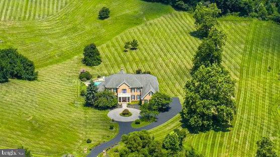 An Amazing & Rare One of a Kind Grand Estate Home with a Multitude of Presious Features ALL IN ONE HOME Overlooking 3.4 Acres!!! And It Is Very Well Appointed & Matched with Incredible Rare Enhancements that will Keep You Happy & Relaxed!! 4 Bedrooms, 4 Full Bathrooms, 4 Walk In Closets, 3 Car Side Load Garages, 3 Fabulous & High-Quality Crystal Chandeliers, A Magical Grand Heart Shaped Double Foyer Staircase, 20+ Ft. Ceilings Delight Those Who Enjoy the Family Room & Entry Way!! Plus, A Memorable Spectacular Masonry Fireplace with a 16+ Ft. Mantle to Ceiling Mirror Adorns the Remarkable Family Room!! And A Magnificent CHEF Granite Gourmet Kitchen & 2 Tremendous Open & Airy SUNROOMS further Encourage You to RE-ENERGIZE Yourself Each & Every Day!!! Radiant & Exquisite Hardwood Floors Throughout & Exceptional & Upscale Ceramic Floors too!! 6 Ornate & Lavish Columns & Dining Room Trey Ceiling adds a Very Extravagant & Classy Glow to this Already Warm & Upscale Estate Home!! 8 Impressive Ceiling Fans throughout this Fantastic Home & 2 of them are Very Unique Paddle Fans!! Exceptional High Level of Workmanship Highlight the Brick Quoining on the Exterior of this Top-of-The-Line Estate Home plus 7 Hi-Tech Exterior Security Cameras & the Entire Interior Boasts A Full Hi-Quality Sound System Plus Built In Speakers!! And A Top-Quality Blue Horizon Pool with Tanning Platform, Waterfall, Deluxe Stone/Brick Patio & a Fire Pit!! Beautiful Landscaping plus An Impressive Regal Circular Driveway Awaits You Each Morning & Evening as You Access Your Majestic Environ!! Only Moments Away from Your Front Door is Old Town Leesburg with many Jolly & Enjoyable Restaurants-Bars, Shops & Joyous Activities!! Leesburg's Executive Airport is right around the corner & Dulles International Airport is 20 minutes down Route 28!!! An easy ride to Tysons Corner, ONE Loudoun & Winchester all on Route 7!! A Day or A Weekend at Charles Town Raceway is a quick drive-up nearby Route 15!! Virginia Vineyards & Craft Beer Breweries are all around you to Enjoy on those Delightful Times when You, Family & Friends want to Imbibe & Celebrate an Outstanding Event or just share a Hospitable & Happy Fun Time!!! COME & EXPERIENCE THIS RARE, UNIQUE & ONE OF A KIND ARRAY OF THE MOST IMPRESSIVE FEATURES ON THE MARKET FOR SALE!! And the Best part of Owning this Grand Estate Home is You do not need to over pay for a 6 or 7 bedroom house and You do not need to over buy for a finished basement that You do not need in order to get All of The Amazing Luxuries that this EXQUISITE HOME Has Now!!! BUY NOW ... ENJOY NOW ... GROW LATER when You need the extra space!!! And if You do You can Create EXACTLY the basement features You Want!!! !!!