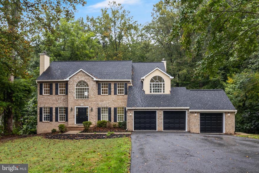 This is a RARE find - this gorgeous brick front Colonial is truly two-homes-in-one!  It features a total of 5 Bedrooms, 5 1/2 Baths, and 3 Car Garage in a sprawling 5,523 total square feet, all nestled into the prestigious Avila neighborhood in Davidsonville.  The floor plan is the perfect blend of upscale colonial design married to an adjoining 2-story suite, perfect for multi-generational, au pair, or guest living.  Each space perfectly flows together, yet provides separate entrances, so combined or separate living is a breeze.  Upon entering any entrance, you will immediately be wowed by the gleaming hardwood floors throughout.  Within the "main quarters" you will enjoy quiet moments relaxing in the sun-lit living room with wood-burning fireplace. Or gather in the cozy family room, with access to the private outdoor deck, with family or guests.  Whether you choose to dine in the formal dining room, or more casually in the kitchen's nook, you will love food preparation in the gourmet kitchen.  The kitchen has been recently updated and features quartz counter tops, under cabinet lighting, dual wall ovens, large island with down-draft cook top, large pantry, and cabinets with pull-out drawers.  The office of the family room makes working from home a no-brainer - or use it as a playroom for the youngsters.  Each of the four large bedrooms upstairs feature gleaming hardwood floors.  Of course, the highlight is the Primary Bedroom Suite, which includes cathedral ceilings, separate sitting area, walk-in closet, ceiling fan, and an ensuite bathroom with jetted soaking tub and walk-in shower.  The lower level provides flexibility in living.  Its open recreation room is perfect for an exercise room, game room, or other interests. You will absolutely love all of the storage available throughout the house - especially the lower-level storage room.  Wine enthusiasts will cherish the dedicated wine cellar.  And the handiest tinkerers will love toiling in the 24' x 14' workshop.  The 2-Story In-law/Au pair suite features gleaming hardwood floors, a separate kitchen, 19' x 12' Living/Dining area, 13' x 11' bedroom with ceiling fan, and modern bathroom with tub/shower combo on the main level. On the lower level, there is a separate family room, full bathroom, laundry room, and storage room. The third garage provides direct access and usage to the in-law suite. Living in Avila means enjoying the best of Davidsonville’s luxury lifestyle while still having easy access to Baltimore, Annapolis, Washington D.C., and nearby boating, shopping and dining. Don’t miss this RARE chance to own a home that combines location, square footage, and upscale elegance.