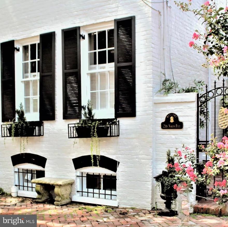 This beautifully reimagined, light-filled semi-detached 1880 Colonial brick residence with a private side entrance has been thoughtfully renovated under the guidance of a talented interior designer who balanced historic character with modern ease. The result is a home that feels both timeless and effortlessly livable.

The main entrance has been thoughtfully placed on the right side of the home. A decorative iron gate opens to  the brick courtyard, offering enhanced privacy and security while creating a gracious and secluded approach to the residence. 

Inside, the entry sits perfectly between a welcoming family room and an updated, chef-inspired kitchen designed for both entertaining and everyday living. Just beyond, a door leads to a serene enclosed garden with a wooden privacy fence and brick patio — an ideal setting for morning coffee, evening grilling, or relaxed gatherings. A discreetly positioned powder room completes the main level.

New flooring over the original hardwood floors anchor the living spaces on the main floor, while a gas fireplace creates a warm focal point in the living room. The gated front entrance framed in iron adds an extra layer of charm and distinction. Along the rear, newly installed privacy fencing is softened by curated plantings that will bloom beautifully with the seasons.

Upstairs, the original wood flooring sets the tone for the well-appointed ensuite bath to the primary suite and added closets to each of the three bedrooms, enhancing both comfort and functionality. Windows on three sides fill the home with natural light throughout the day, highlighting elegant crown and chair-rail moldings as well as thoughtfully integrated built-ins.

The laundry is in the basement that is otherwise used for storage as the ceilings are currently  low. 

Perfectly positioned just half a block from the center of Old Town, the home offers the rare combination of peaceful residential living with immediate access to shops, dining, and neighborhood life. 

****Transportation********
Alexandria is committed to making cycling a safe and convenient method of travel for residents to live, work, and play. The King St and Braddock Rd Metro stations are less than a mile away, Ronald Reagan Washington National Airport is 3 miles for easy commuting in and out of town and their are a variety of other options including buses, Potomac Water Taxi, and the fast, free, and fun King  Street Trolley.

******What is there to do nearby?*****

Old Town Alexandria features over 200 independently owned restaurants and boutiques, primarily concentrated along the1-mile stretch of King Street. The historic district includes more than 100 specialized, locally owned shops, alongside a high density of dining options ranging from casual cafes to waterfront fine dining.

Key Parades in Old Town Alexandria  include the Alexandria Scottish Christmas Walk Parade, Holiday Boat Parade, George Washington Birthday Parade  and the St. Patrick's Day Parade. 

Just moments away, the Old Town Farmers’ Market—the nation’s oldest continuously operating farmers’ market—has been a community gathering place since the days when George Washington sent St. Patrick's Day Parade produce from Mount Vernon to be sold here. Today, this beloved Saturday tradition features more than 70 vendors during peak season, offering fresh produce, artisan foods, flowers, baked goods, and handcrafted items—blending Alexandria’s rich history with vibrant local living.