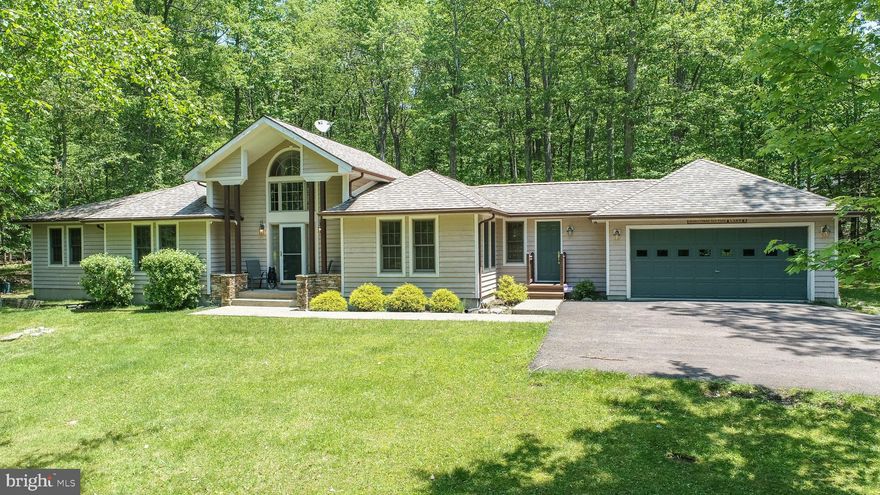 It’s here! And priced to sell! An updated rustic-modern home with lots of privacy on a large wooded lot in the coveted Mountainside Resort of Deep Creek Lake.

Discover rustic elegance and modern comfort in this beautifully updated 3-bedroom, 2.5-bath lake access home nestled on a private, wooded 1.18-acre lot in the coveted Mountainside community at Deep Creek Lake. Offering one-level living and a warm, inviting atmosphere, this property blends mountain charm with upscale finishes.

Step inside to find brand-new luxury flooring, granite kitchen counters, sleek stainless steel appliances, and modern rustic light fixtures. Large windows in the living room flood the space with natural light and frame peaceful views of the surrounding woods. The seamless layout provides easy living all on one level, including a spacious primary suite.

Relax and unwind on the quiet back deck, complete with a hot tub, or gather around the fire pit in the backyard after a day of lake or mountain adventures. The oversized front yard and paved driveway enhance the property’s appeal, along with a spacious two-car attached garage.

Located in the prestigious Mountainside community, enjoy exclusive amenities including private roads, a lakefront clubhouse with a party room, kitchen, restrooms, and canoe/kayak storage. Swim, play tennis or basketball, and soak in the serene lake setting. Centrally located to restaurants, shops, marinas, and just 5 minutes from Wisp Resort, this home offers year-round enjoyment. Boat slip possibilities via HOA lottery.

This is mountain lake living at its finest—schedule your showing today!