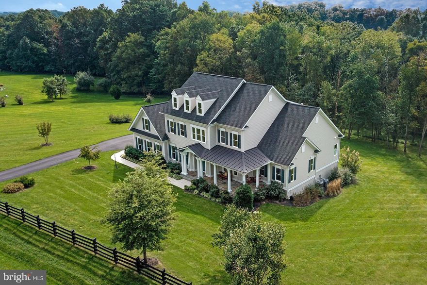 A must see! Sun-Filled home w/ no detail overlooked & highest level of quality throughout. This stunning home sits on over 3+ open acres. Generous main level master suite, gourmet kitchen w/ top-of-the line SS appliances, over-sized dining room, generous family room w/ wall of windows overlooking verdant woods & property. Hardwood floors on all 3 lvs, screened porch, hot tub, 3-car garage, & more!