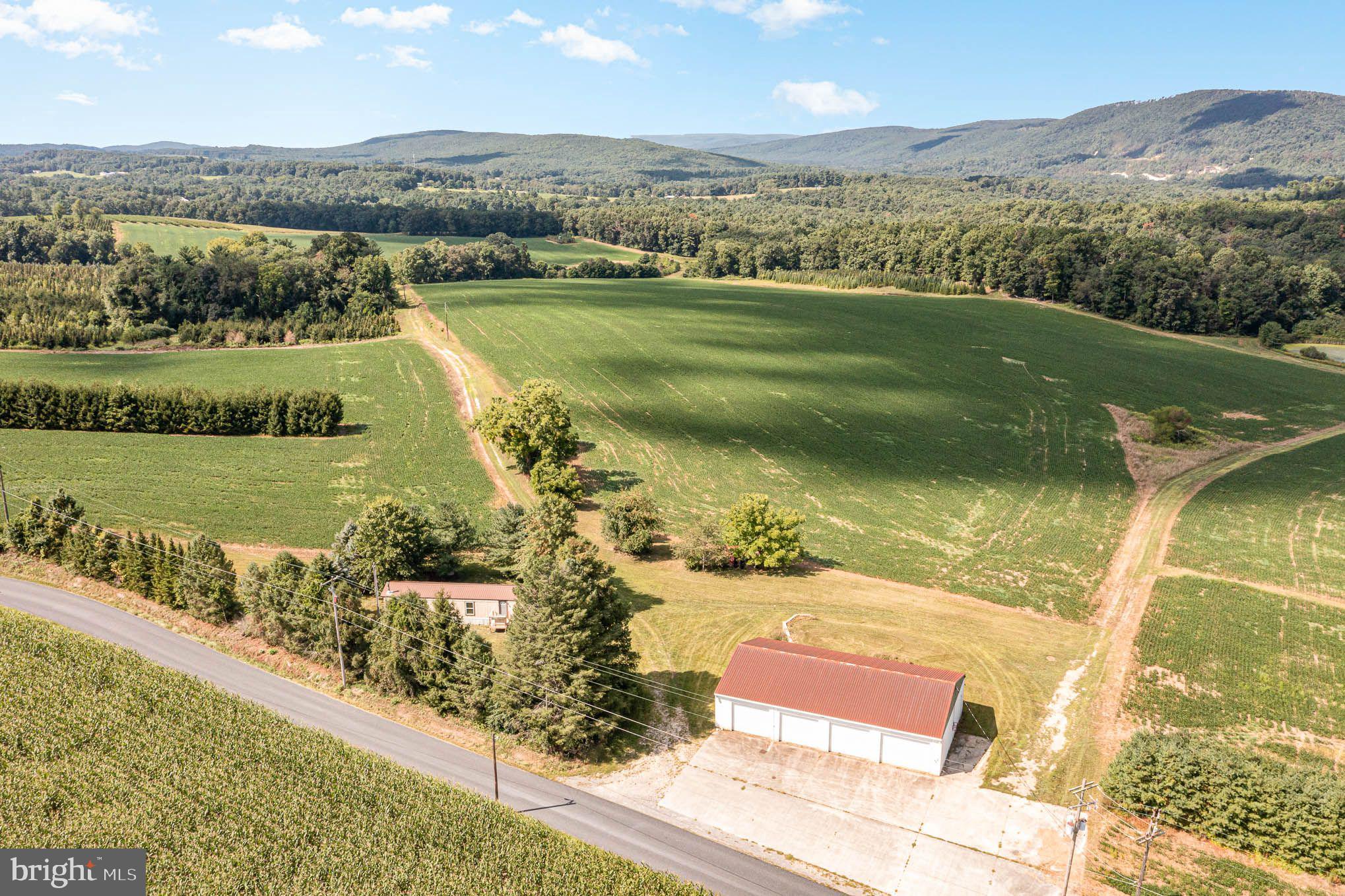 Enjoy nearly 200-Acres of Multi-Use Land backing up to Pennsylvania State Land. Included on the property are 2 ponds (ready for catching bass and trout). The land is diverse in its attributes, with the possibility for many uses including Hunting, Sub-Dividing, Crops, Orchards, Timber, Camping, Hiking, and Family Relaxation. In addition, there is a Mobile Home/Cabin with a well and septic, plus a 4-car garage/pole barn. The cabin sleeps 8 and has 2 bedrooms and 1 full bathroom decorated as a stylist wood-paneled lodge which sports a coordinated, comfortable, open living environment.
