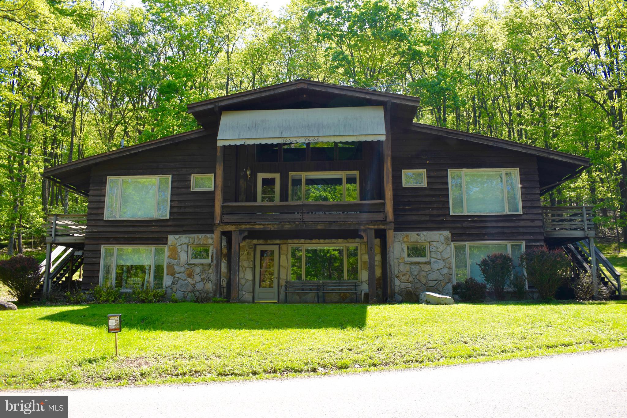 Located in the desirable Alpine Lake Resort this Chalet offer 6 Bedrooms and 7 Baths. Within walking distance to the lodge & golf course. Lower Level living room has a stone wood burning fireplace and bar. Upper Level living room has large stone wood burning fireplace, covered balcony, wet bar, cathedral ceiling done in tongue & groove with exposed beams. Each bedroom offers separate outside access and full bathroom. Plenty of room for all! Call today.
