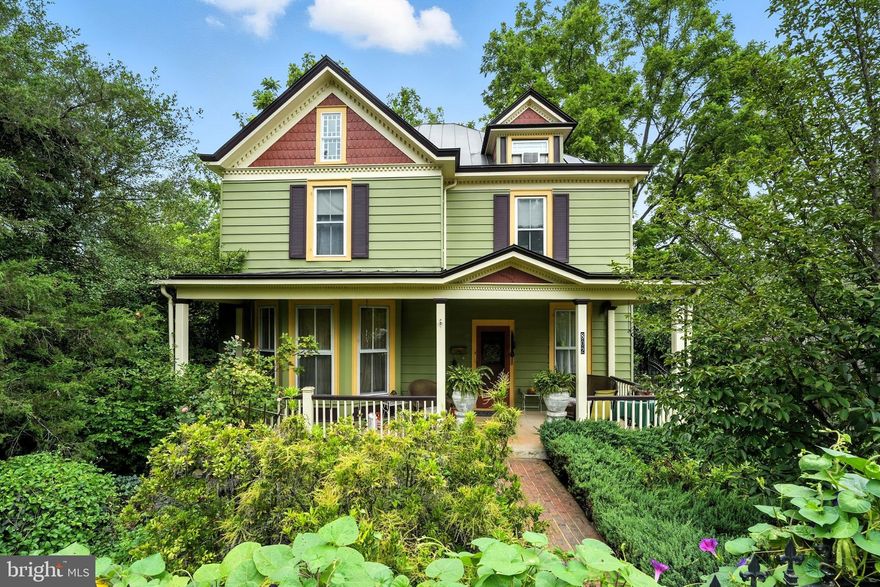 One of Culpeper’s Most Iconic and Recognizable Homes, This Gorgeous Victorian is a Testament to Days of Yesteryear.  A true oasis in every sense of the word, this in-town private retreat is situated on two lots totaling over half an acre, and boasts over 2,500 square feet of carefully curated and modernized living space.  
A light filled oversized foyer welcomes you as you enter the home, complete with hand laid hardwood flooring, high ceiling, and touches of original hardware adorning the space.  The living room invites relaxing evenings or fun gatherings, with built-ins, picture railing, and a beautiful bay window and banquette.  Cozy separate dining room just off the kitchen, with access to the side deck.  The granite-clad kitchen serves as a chef’s haven, with a 5 burner down draft gas stove and stainless-steel appliances.  The main level also offers a den complete with picture ledge, wainscotting and recessed lighting, mud room from the rear entry, laundry and full bath.
Rich in character, the high ceilings and oversized moldings evoke a sense of grace, punctuated by period details such as picture rails and original stained glass accent windows filtering in gentle light. The rich hardwood flooring carries throughout the home, ensuring its charm, as do features such as the inset glass display cabinet in the rear entry area, wainscotting, and don’t forget the second stairway tucked just beside the kitchen. (late night snacks?)
On the second level of the home, you’ll find 5 spacious bedrooms and a full bathroom.  Any of these rooms may also suit as an office, with one overlooking the back yard and seasonal mountain/sunset views!
Go up yet a floor further and you’ll find a spacious “flex” space that lends itself for ample storage, an additional bedroom space, office, play room, etc.
The home presents a spacious covered front porch, side deck and rear porch, offering various niches and vantage points to relax and enjoy the thoughtfully designed landscape.
The home is set in a lush surrounding of mature plantings, beautiful blooms and the sounds of a tranquil fountain.  You’ll admire the surprising privacy the back yard offers, and the magnificent black walnut tree yielding shade for all.  Meander through the backyard space and appreciate the herringbone brick patio, inviting inground pool, outdoor shower, discreet chicken “coupe” and gardener's nook.  
A detached garage mirrors the home’s style and affords space for vehicle parking and workshop and indoor gardener storage.  There is ample parking tucked behind the home, and the driveway is adorned with a beautiful wrought iron gate for added peace of mind.
All of this nestled in the heart of downtown Culpeper, with shops and restaurants just a few blocks away!  Minutes away from local parks, lakes, medical facilities, etc.
Rarely does a property offer such an exquisite blend of history, space, and modern amenities in a location this vibrant!  Schedule your private tour today and imagine the memories waiting to be made at 802 S. Blue Ridge Avenue.