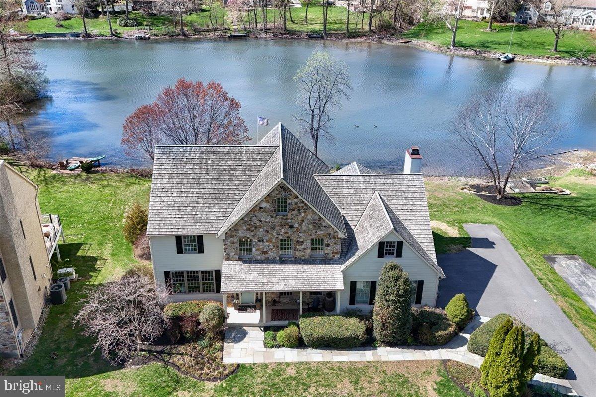 *Sellers have received multiple offers as of 4/14/24, please call listing agent for questions or additional information* Dreaming of living on the water in an ideal location convenient to everything? Now is your chance!!! Don't miss this beautiful lakefront property in the popular Somerset Lake community! As soon as you arrive, you'll know this home has been loved by its current owners. A welcoming front porch greets you, leading to a thoughtfully designed main level with 9 foot ceilings, hardwood flooring, custom moldings, attention to detail, and amazing lake views from almost every room in the home. The elegant open two story foyer features a hardwood staircase and coat closet, and leads to a private home office featuring built-ins and french doors, ideal for today's work from home lifestyle. The spacious and bright living room is open to a large dining room, all with magnificent views of the lake. The heart of the home is the updated kitchen featuring stainless appliances, granite countertops, island with extra seating, a separate breakfast room, and much more! The family room is spacious and cozy with a gas fireplace and french doors leading to a gorgeous sunroom with ceramic tile, vaulted ceilings, walls of windows, and doors to the private deck. Every room feels more special than the one before, and you may have trouble deciding which room is your favorite! Completing the main level is an updated powder room and fantastic laundry/mudroom. Upstairs, the spacious owner's suite is a true retreat with it's vaulted ceilings, spa-like bath with his-and-her vanities and linen closets, two huge walk-in closets, and a private sitting room overlooking the lake. The wide upper hallway leads to three more nicely sized bedrooms with ample closets and more gorgeous views of this property. And there's more!!! The walkout basement is finished for additional living space, a wet bar, another full bath, a home gym, a bonus/play room, additional storage areas, and access to the fabulous paver patio and backyard! This lower level could also be an in-law suite or apartment, with endless possibilities. The outside amenities continue to impress, including a private gazebo, hot tub, professional landscapinng, a private dock, with a canoe and paddleboat that are included! Where else can you find this kind of lifestyle in Chester County a mile from Hockessin and a few minutes from Kennett Square? Somerset Lake is one of a kind in this area, offering sailing, kayaking, fishing, an outdoor pool on the lake, tennis and pickleball courts, a playground, dog park, and a terrific clubhouse with fitness center and game room. Homes on the lake are rarely available and this one is extra special! Additional highlights include new HVAC in 2023, dual zone heat and A/C, fresh paint throughout the home, a 2 1/2 car garage, many replacement windows, and all new Hardie Plank siding on the exterior of the home! Ideally located in the award winning Kennett Consolidated School District, convenient to all major roadways, shopping, employers, restaurants, hospitals, and recreation areas. Call today and you may be the next lucky owner of this fantastic property!!!